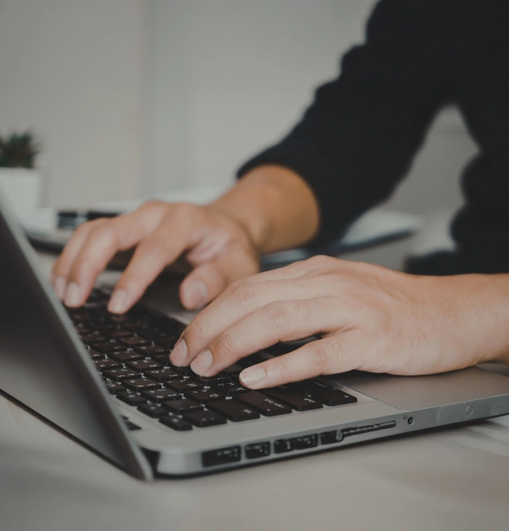 Benefits specialist reviewing employee health plan options on a laptop — Core Group Consulting delivers hands-on support for small and mid-size businesses.