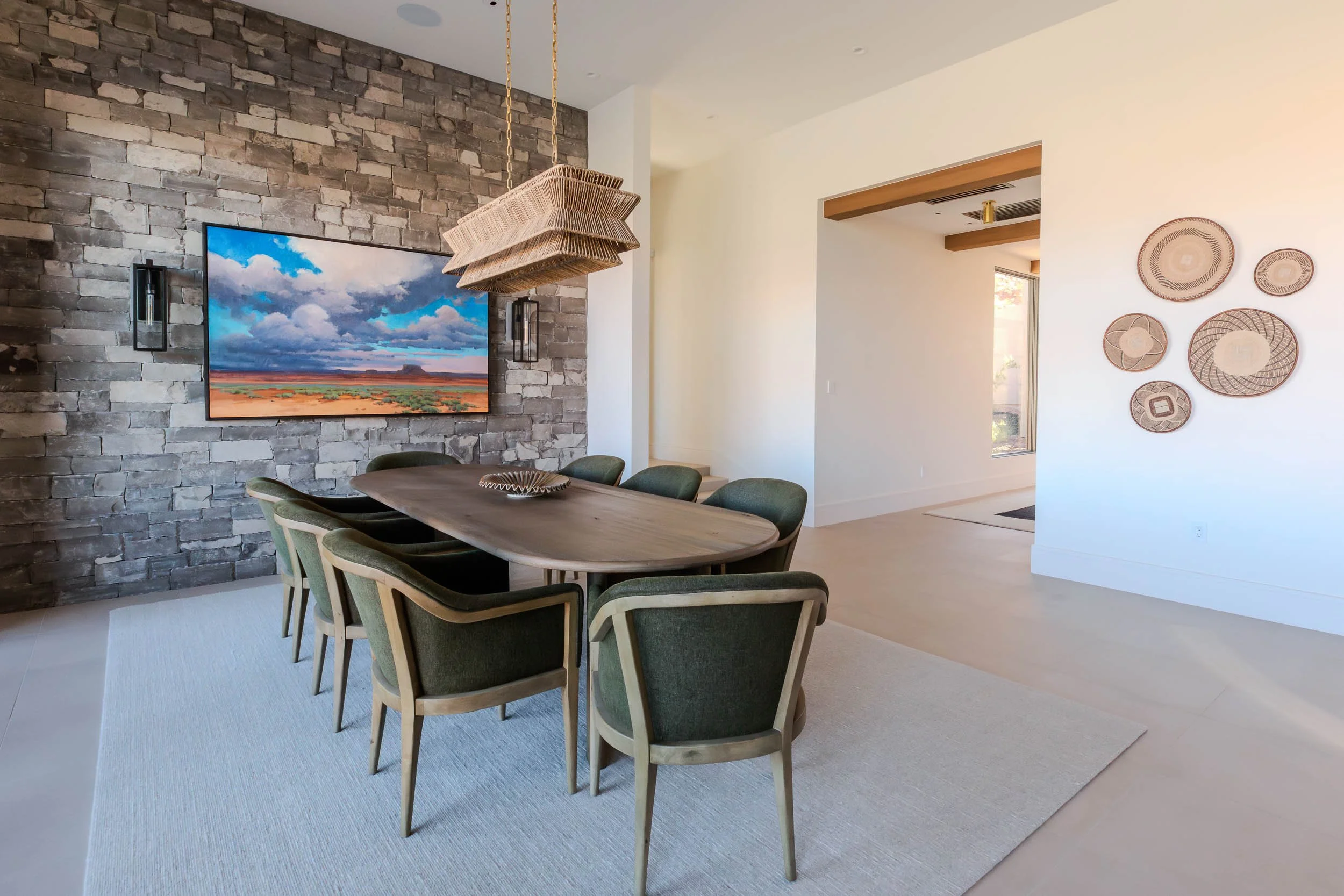 dining room with custom art and woven chandelier