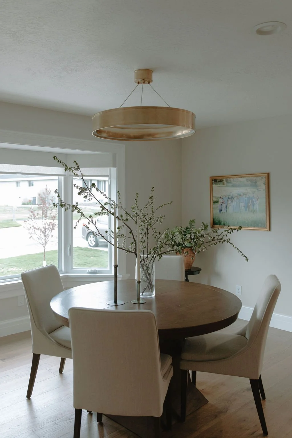 Small dining room with modern pendant and upholstered chairs
