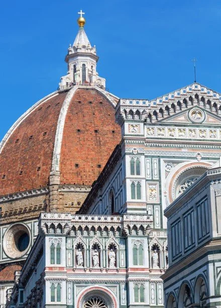 Santa Maria del Fiore cathedral in Florence, Italy, featuring grand arched architecture and intricate historic detailing.