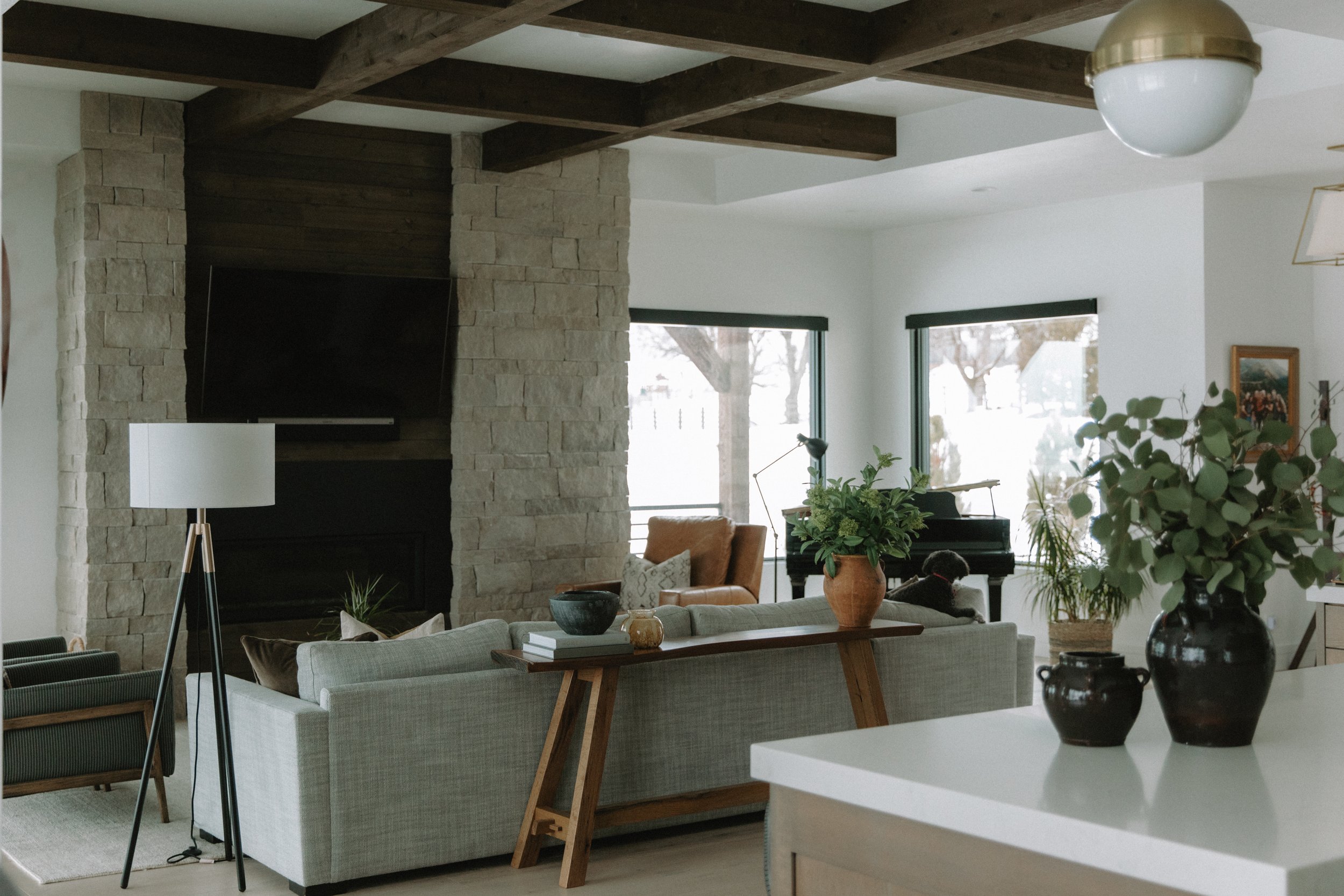 Living room with wooden beam ceiling and fire place