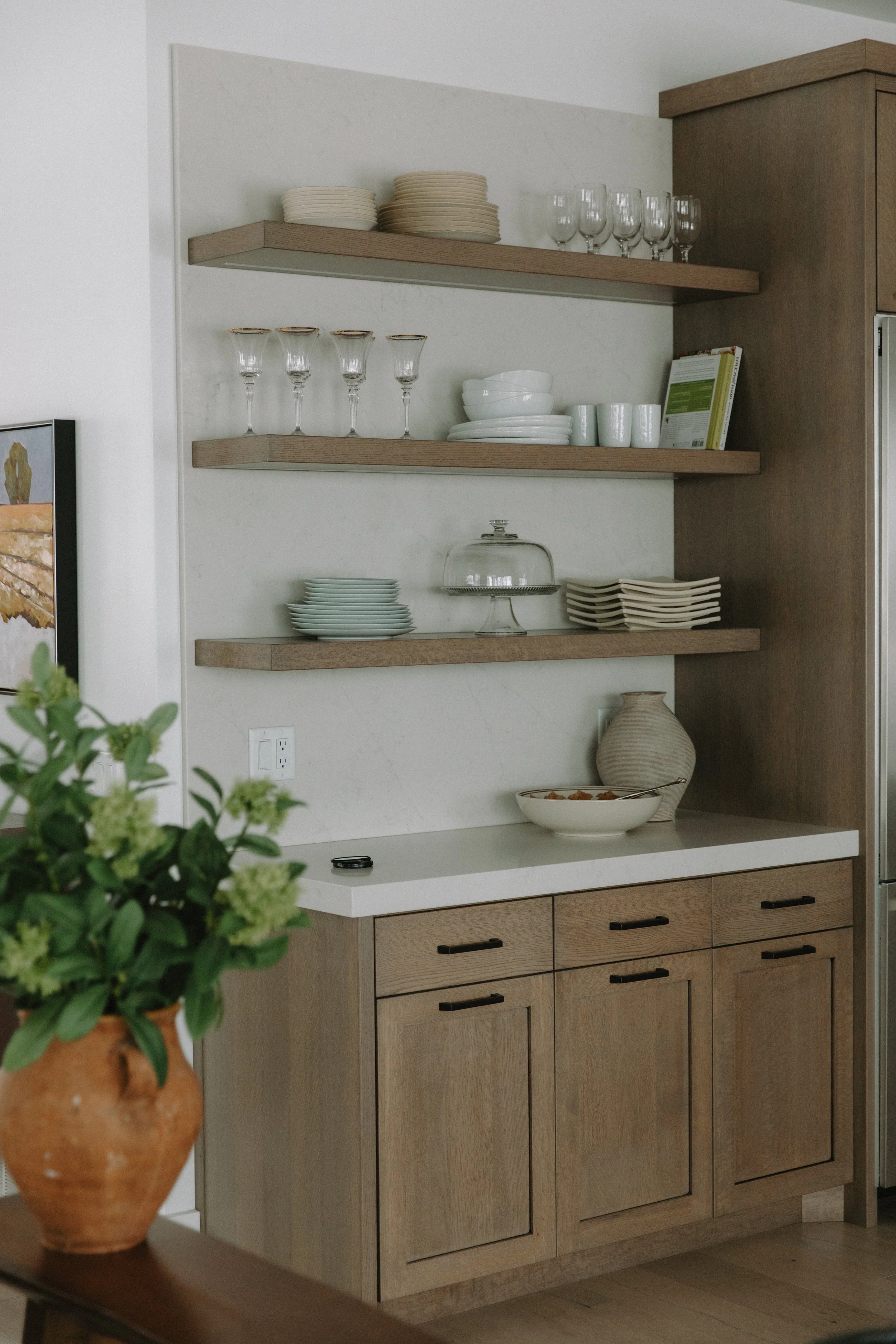 Floating wall shelving in kitchen decorated with glass wear