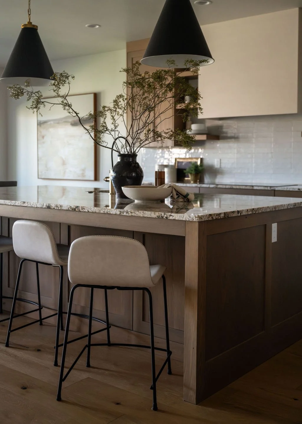 Elegant kitchen island with natural stone countertops, warm wood tones, and a neutral color palette for a timeless design.