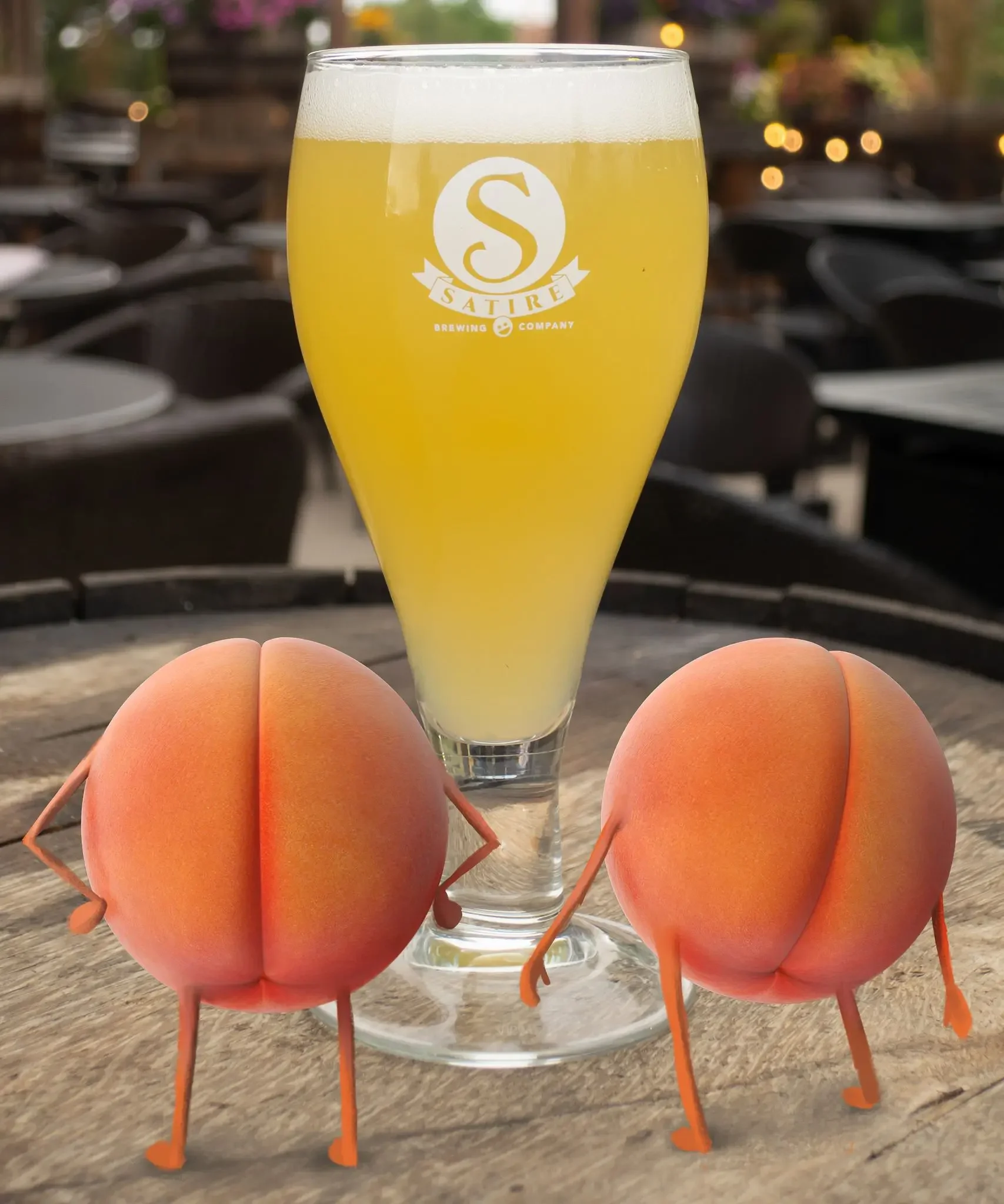 Two brown eggs on orange wire egg holders in front of a tall glass of pale yellow beer with a foam head. The glass has a logo for Sature Brewing Company. The background is blurred with outdoor seating and string lights.