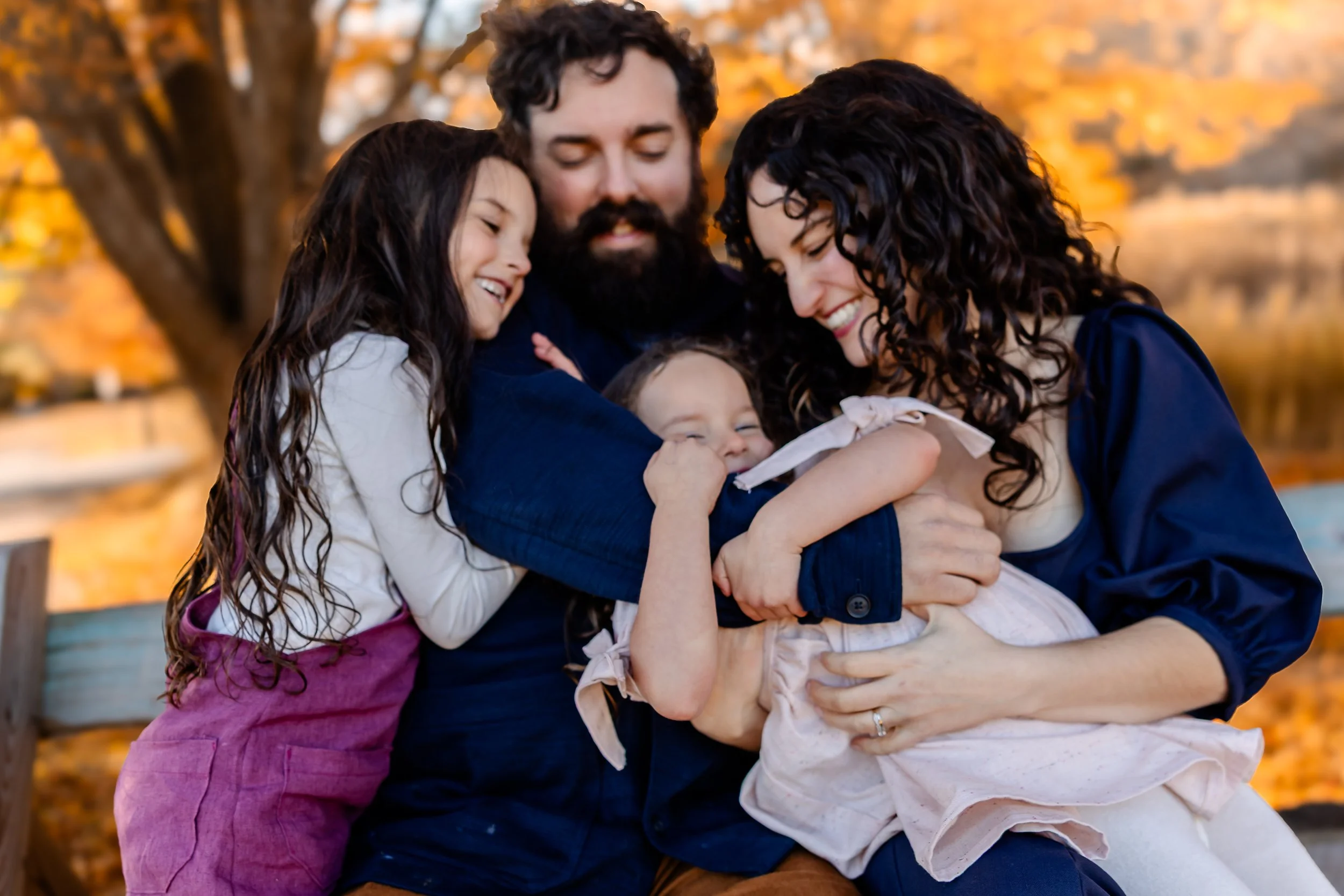 creative entrepreneur with laptop and coffee  Boston family session capturing playful moment between parents and children