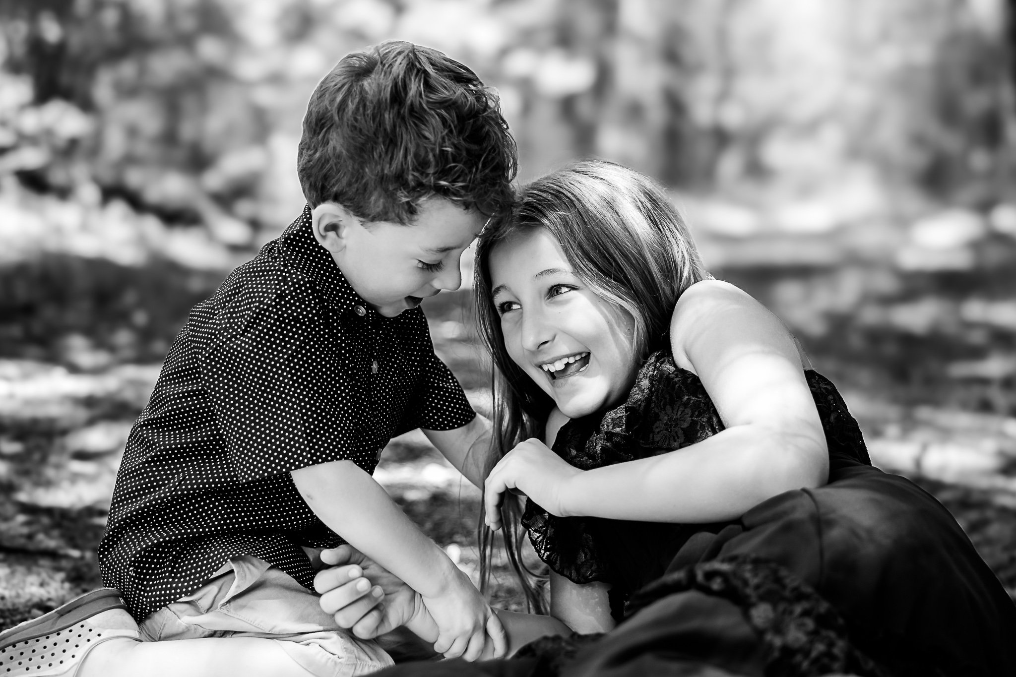 Boston family photographer capturing siblings playing together outdoors