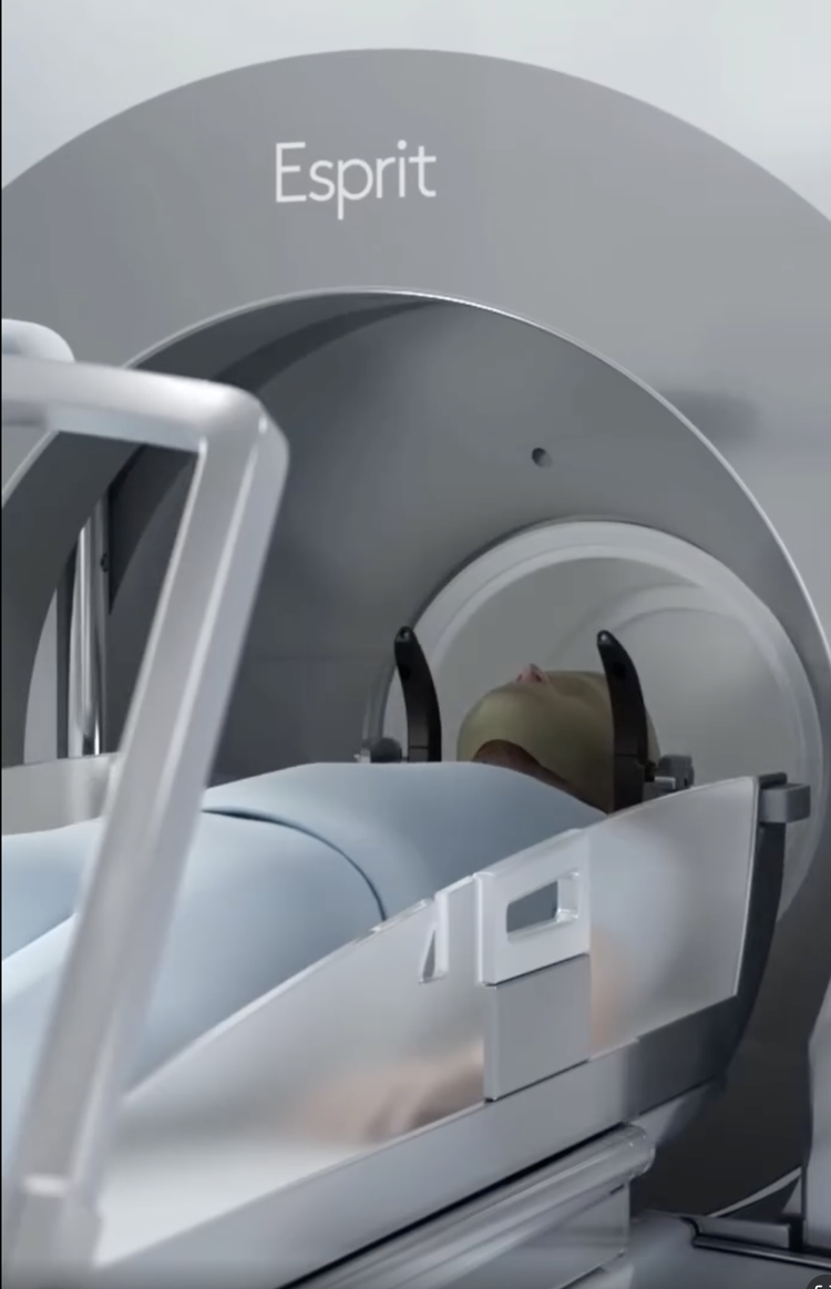 Patient positioned in an Elekta Esprit Gamma Knife radiosurgery unit with head immobilization for stereotactic treatment.