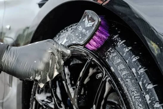 Detailer brushing a tire