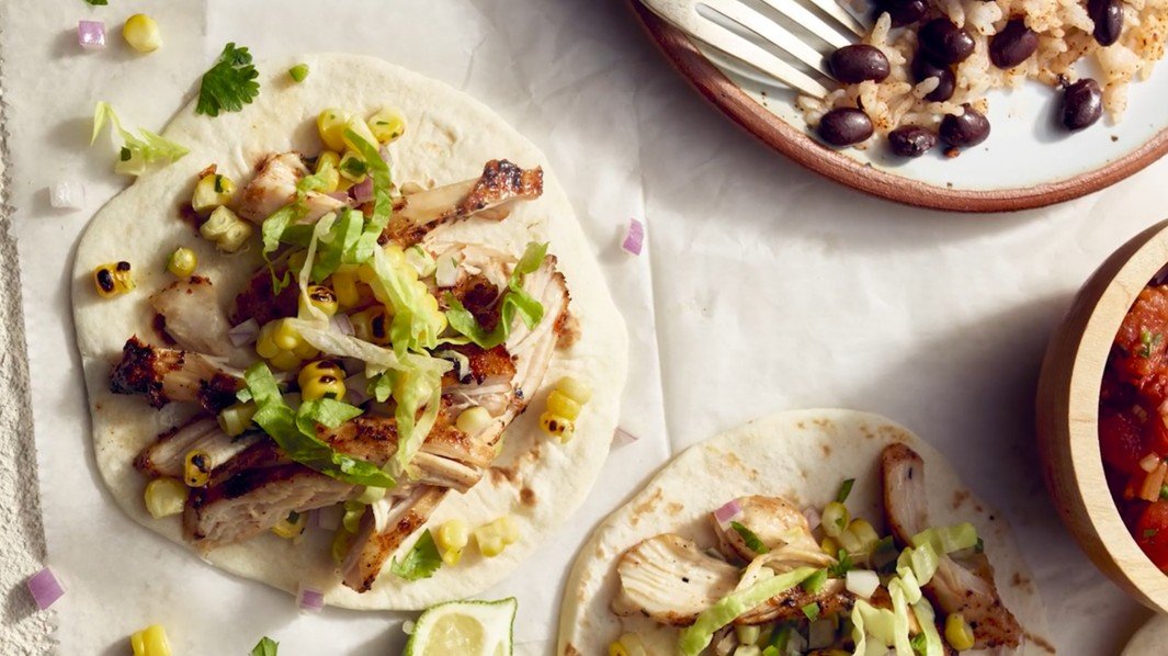 Hand-crafted Yucatán marinated chicken tacos with corn salsa and homemade tortillas, a Royal Blue culinary composition.