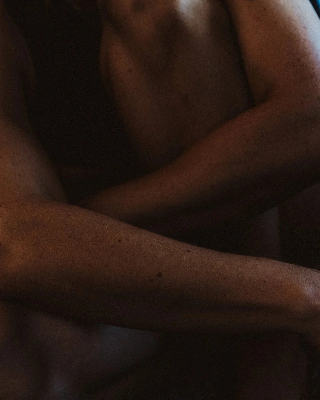 Close-up of human skin, showing textured surface and natural color variations, with some areas slightly darker and others lighter.