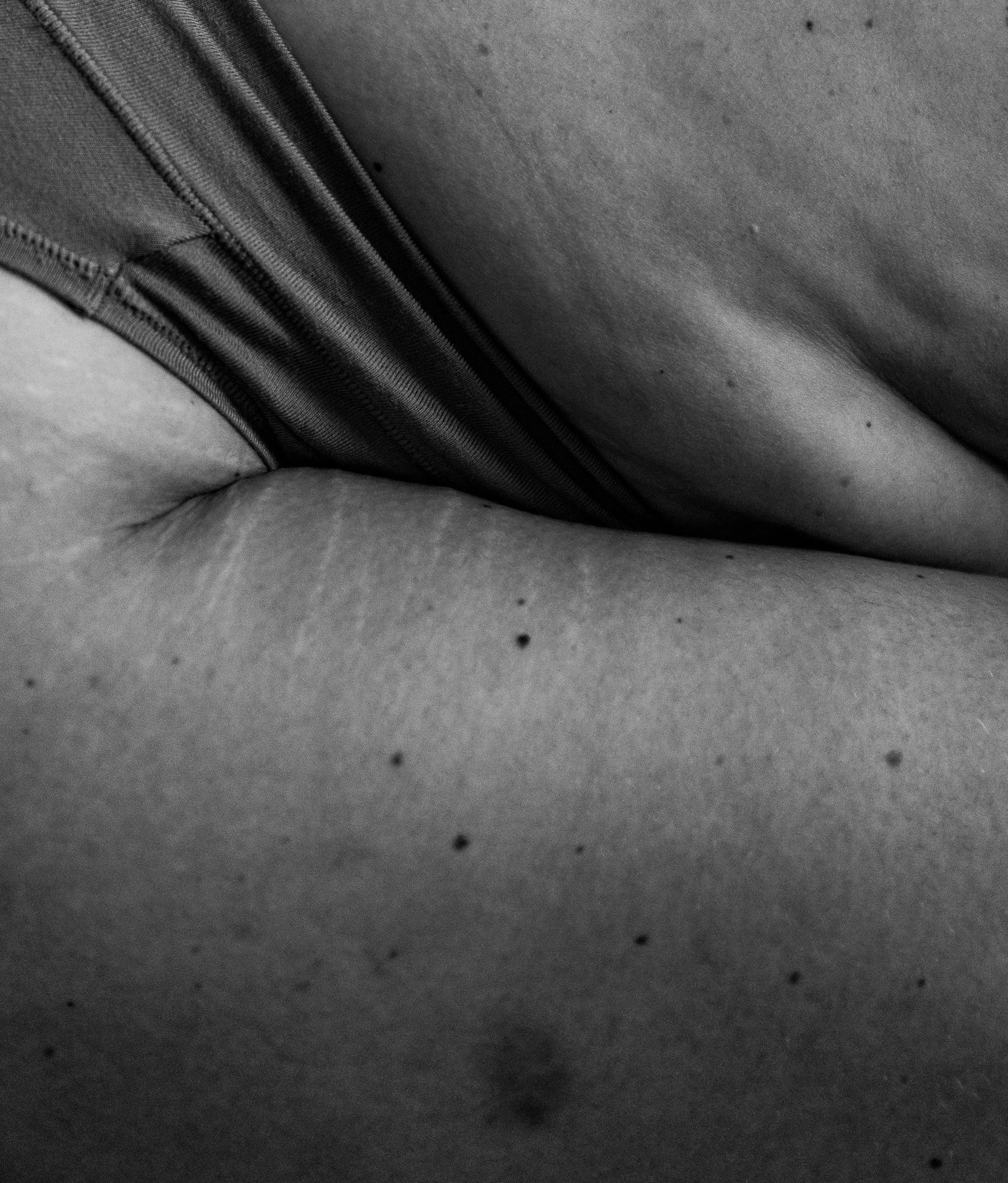 Close-up of woman leaning over, creases, rolls, wrinkles and uneven skin texture