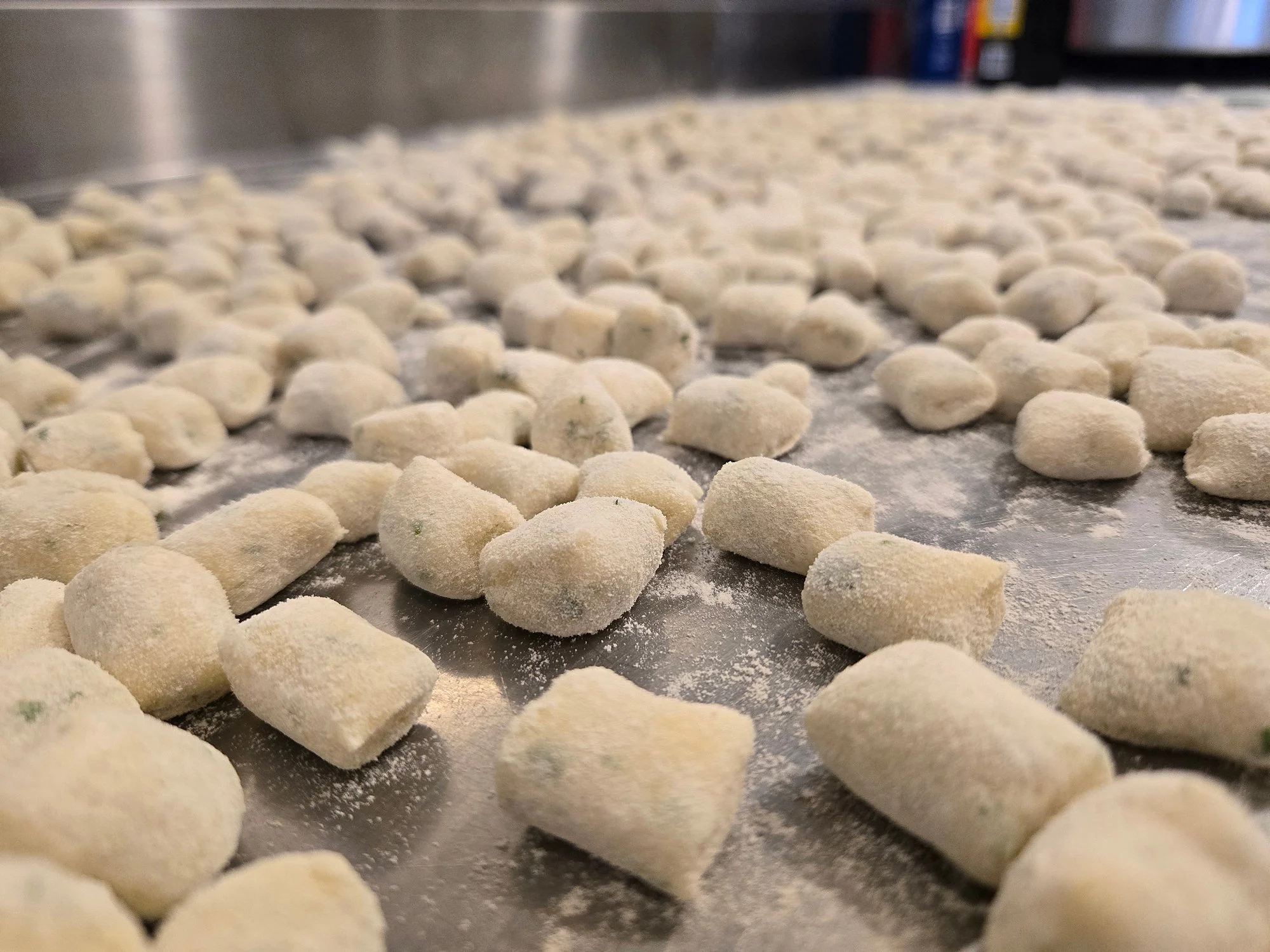 halifax meal delivery | Row of uncooked gnocchi pasta covered in flour on a silicone baking mat.