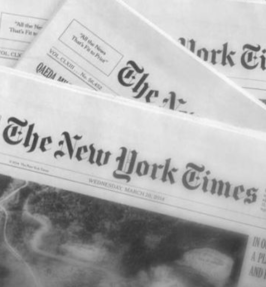 Three folded The New York Times newspapers stacked on top of each other.