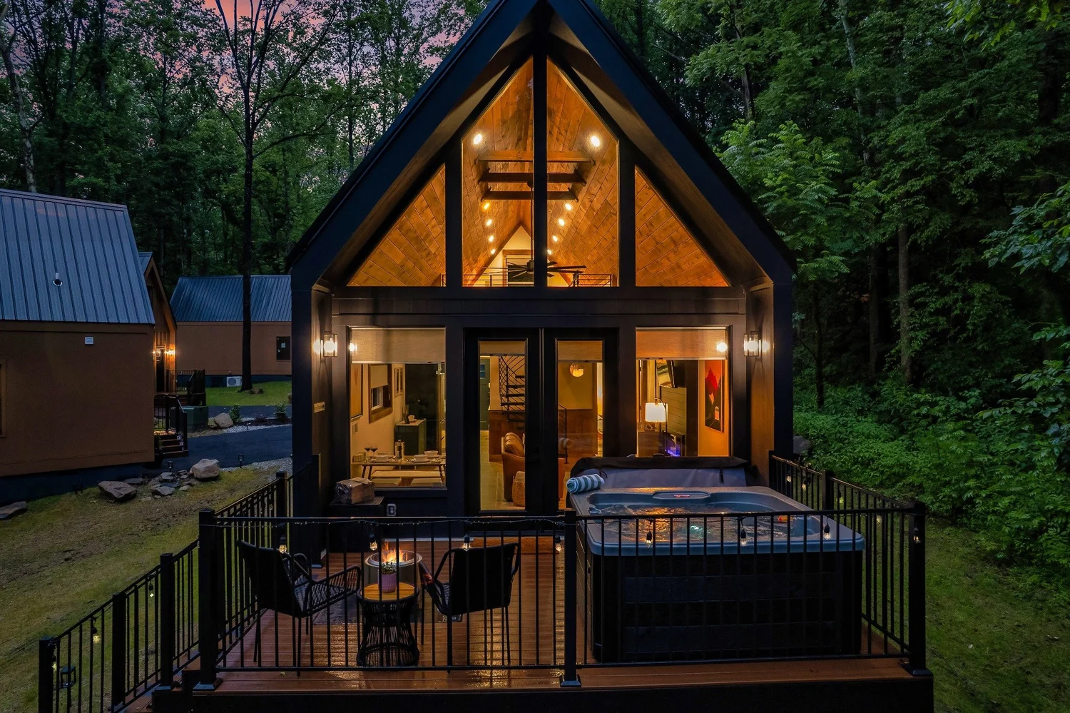 WildNest A-frame cabin illuminated at dusk in Gatlinburg