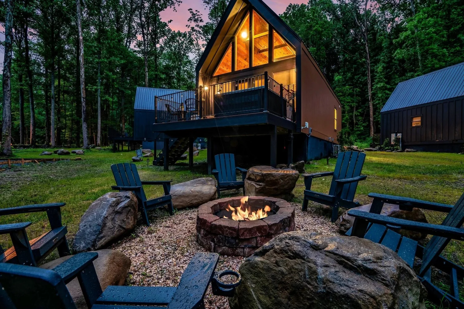 The Finch cabin and creekside firepit at dusk
