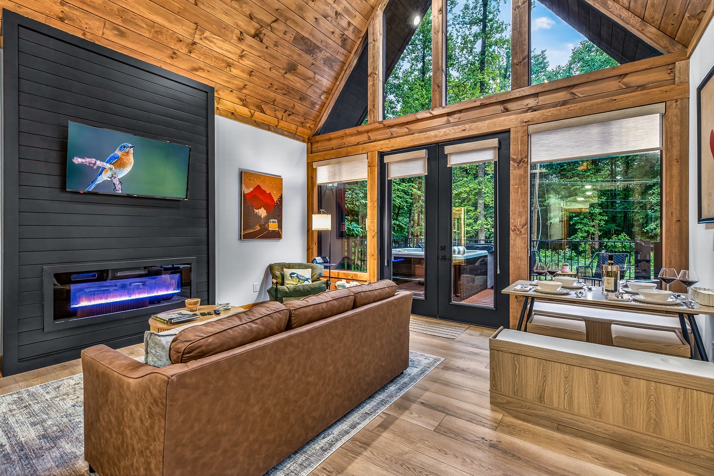 Living area — forest views, a queen sleeper sofa, and room to gather.