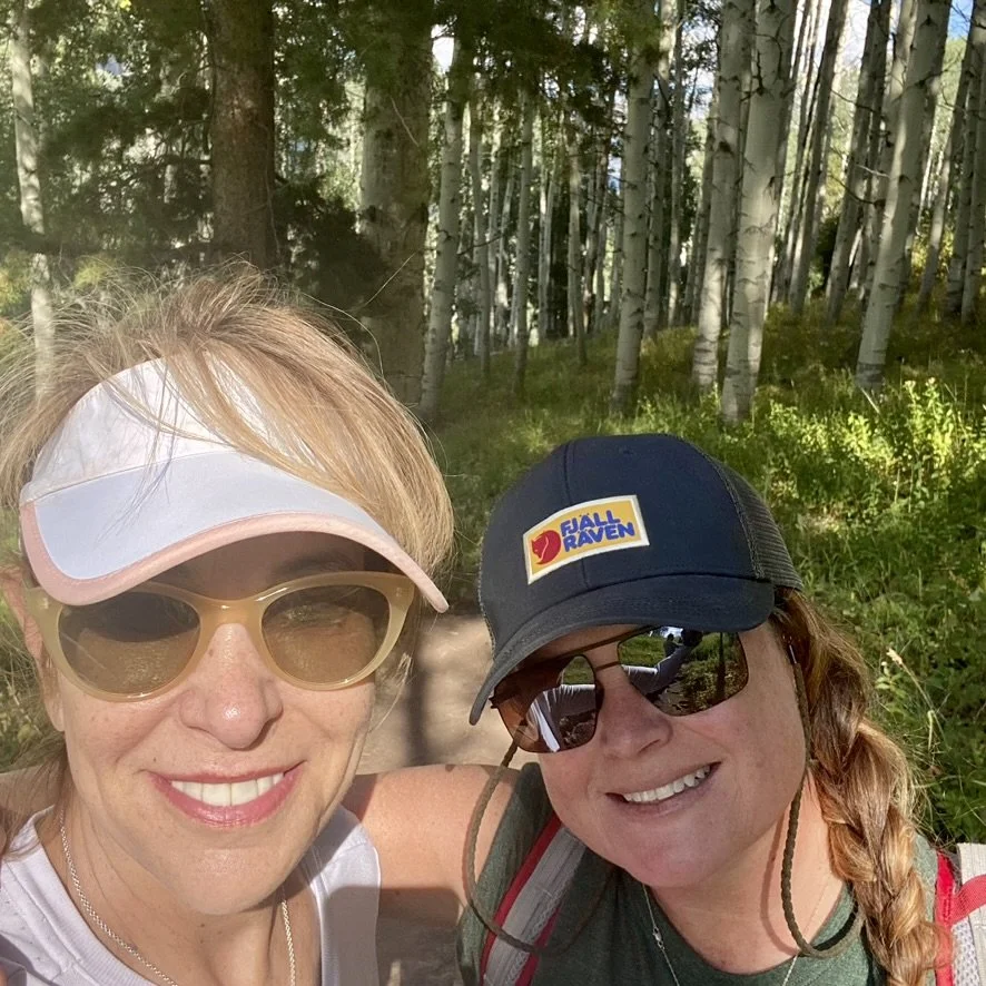 Michele and Jess hiking among the aspens