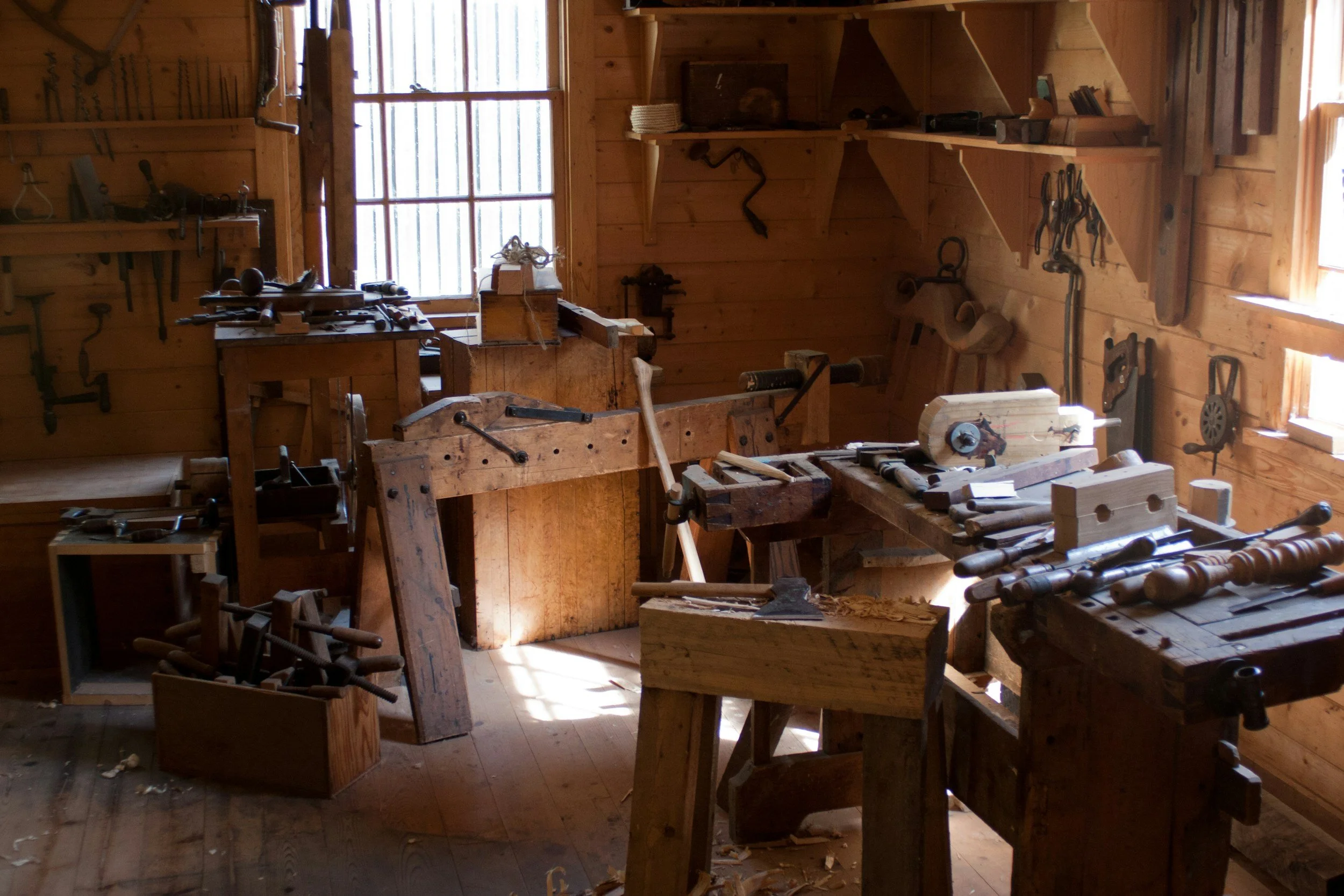 The interior of the Studio Trims woodworking workshop in Avondale Heights, featuring timber workbenches and professional tools