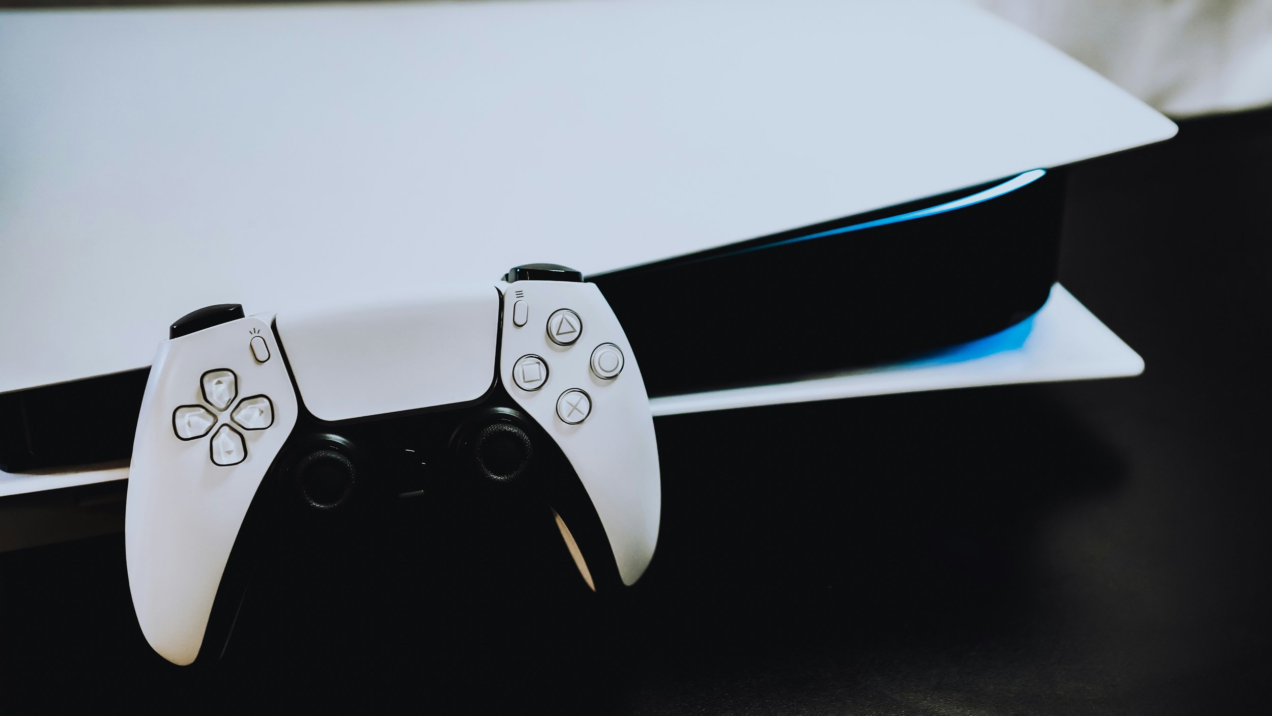 Close-up view of a PlayStation 5 console and controller