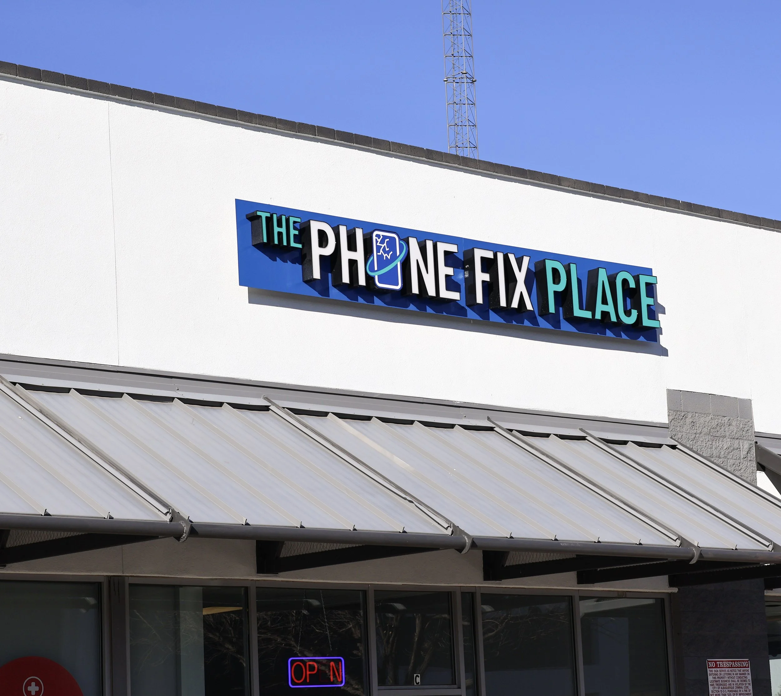The Phone Fix Place storefront sign in Albuquerque offering game console repair services
