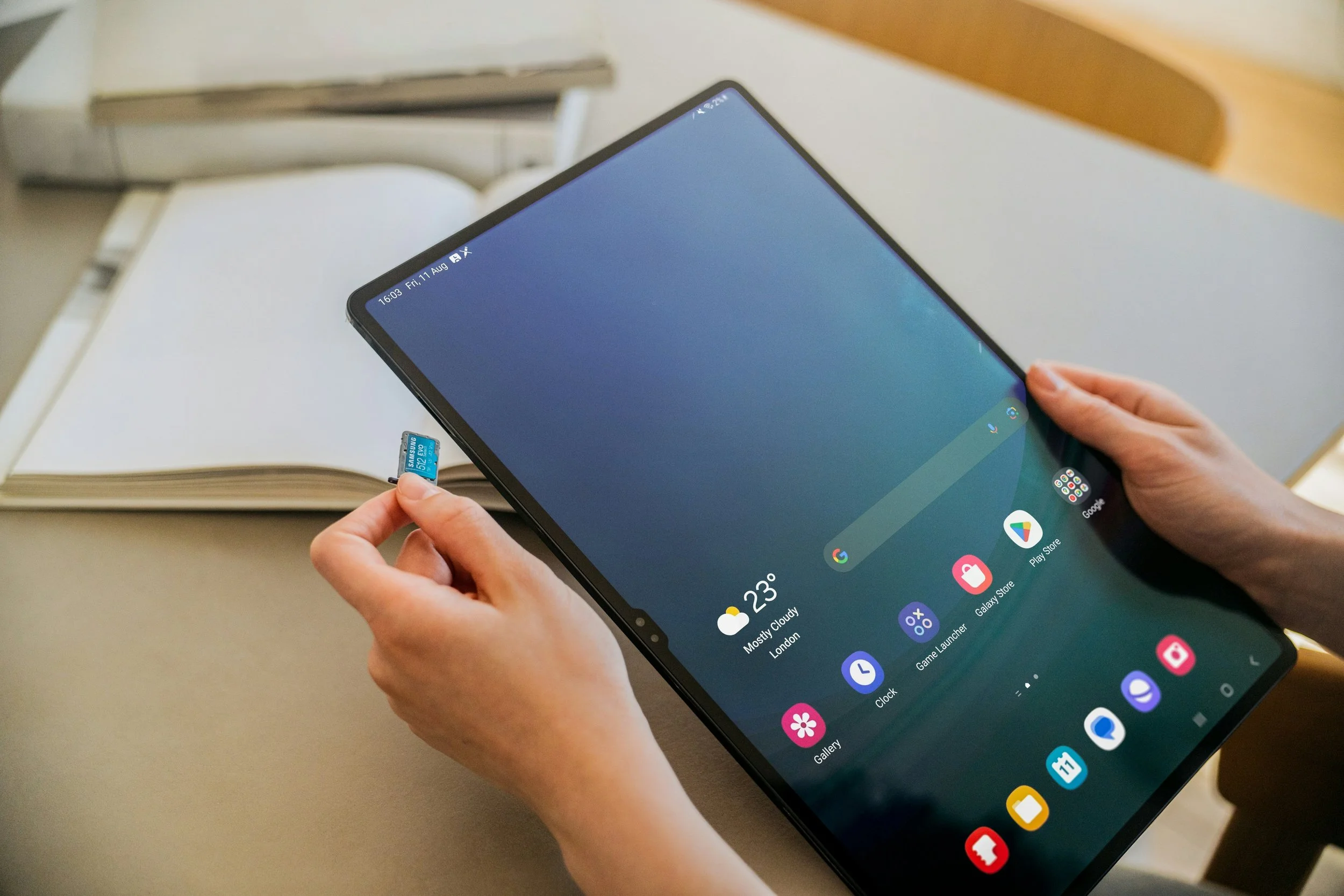 Person holding a memory card for tablet storage