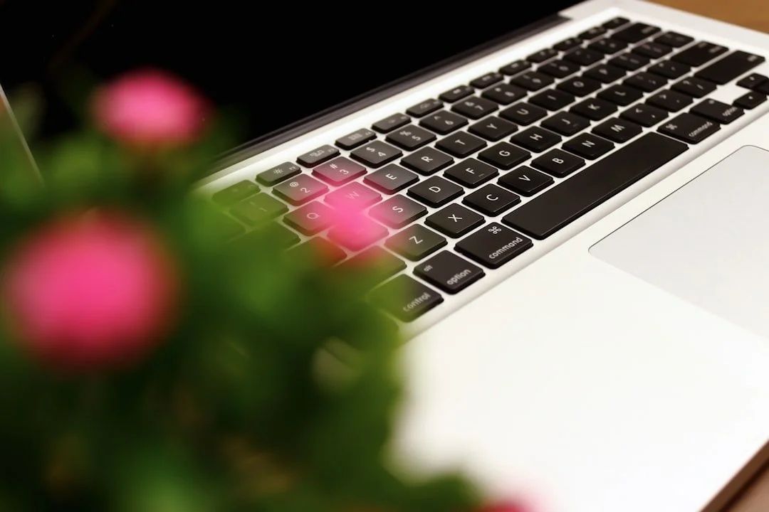 Close-up image of MacBook laptop keyboard and trackpad area.
