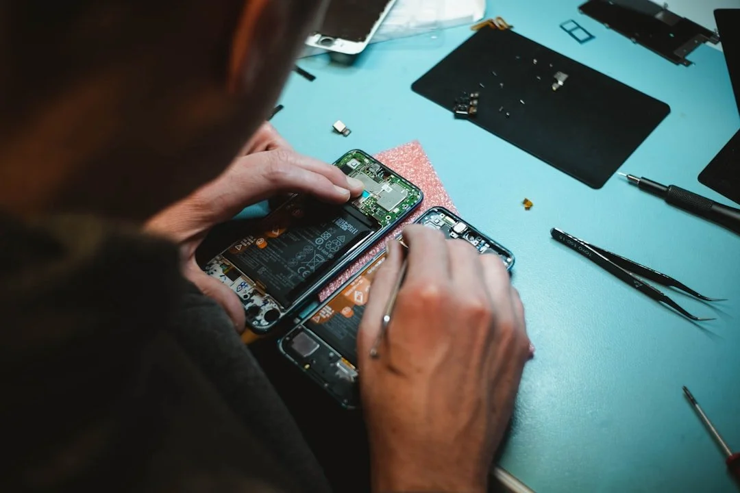 technician carefully working on an iPhone screen