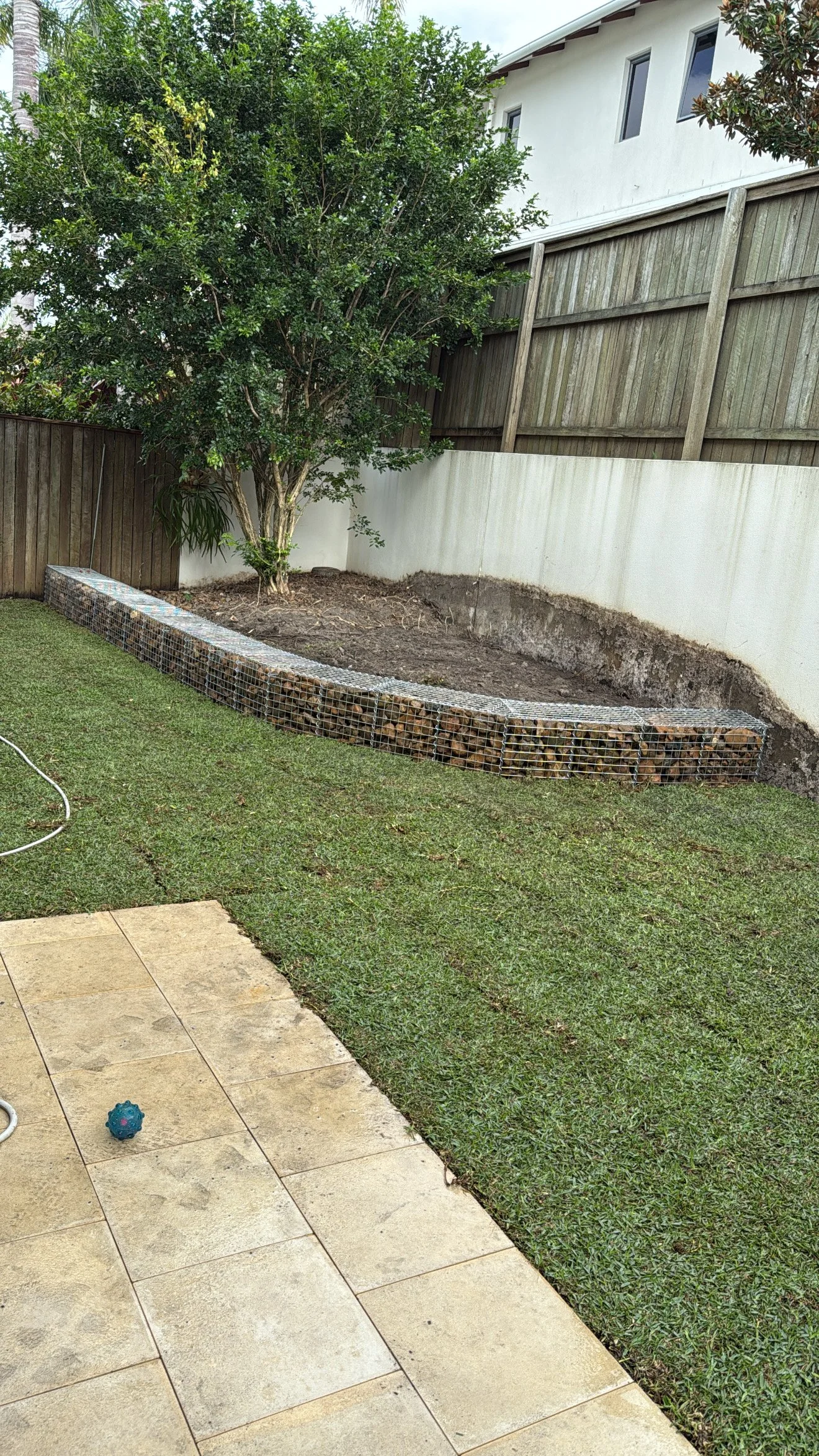The finished job. Rock wall up, turf laid and garden ready for planting.,