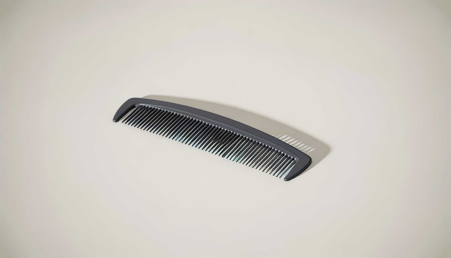 Black hair pick comb mounted on a cream-colored ceiling, casting a slight shadow.