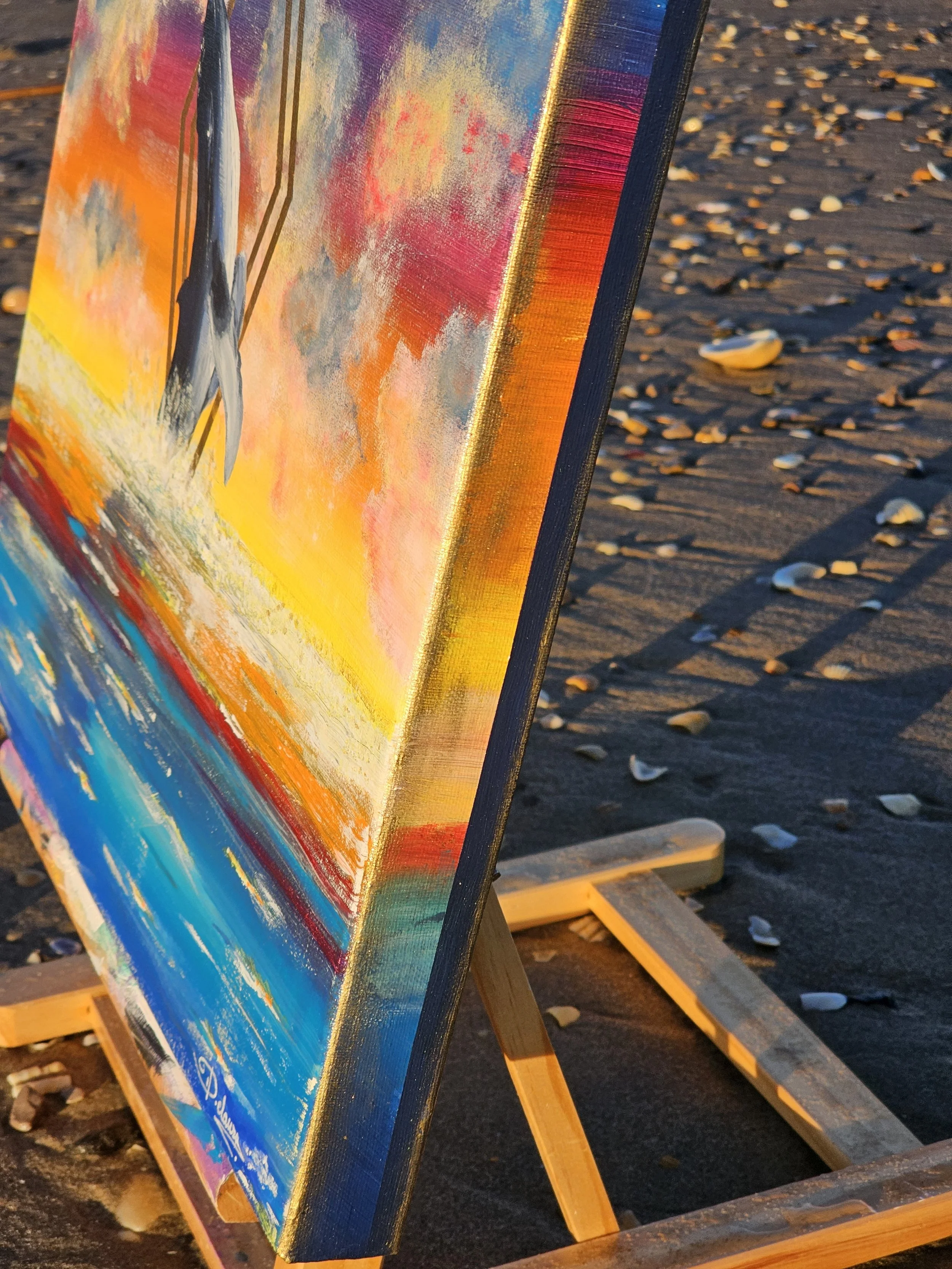 Peinture représentant un océan coloré avec une baleine, "Silence". Elaura Donnadieu, graphiste, illustratrice et artiste peintre. Photo prise sur la plage