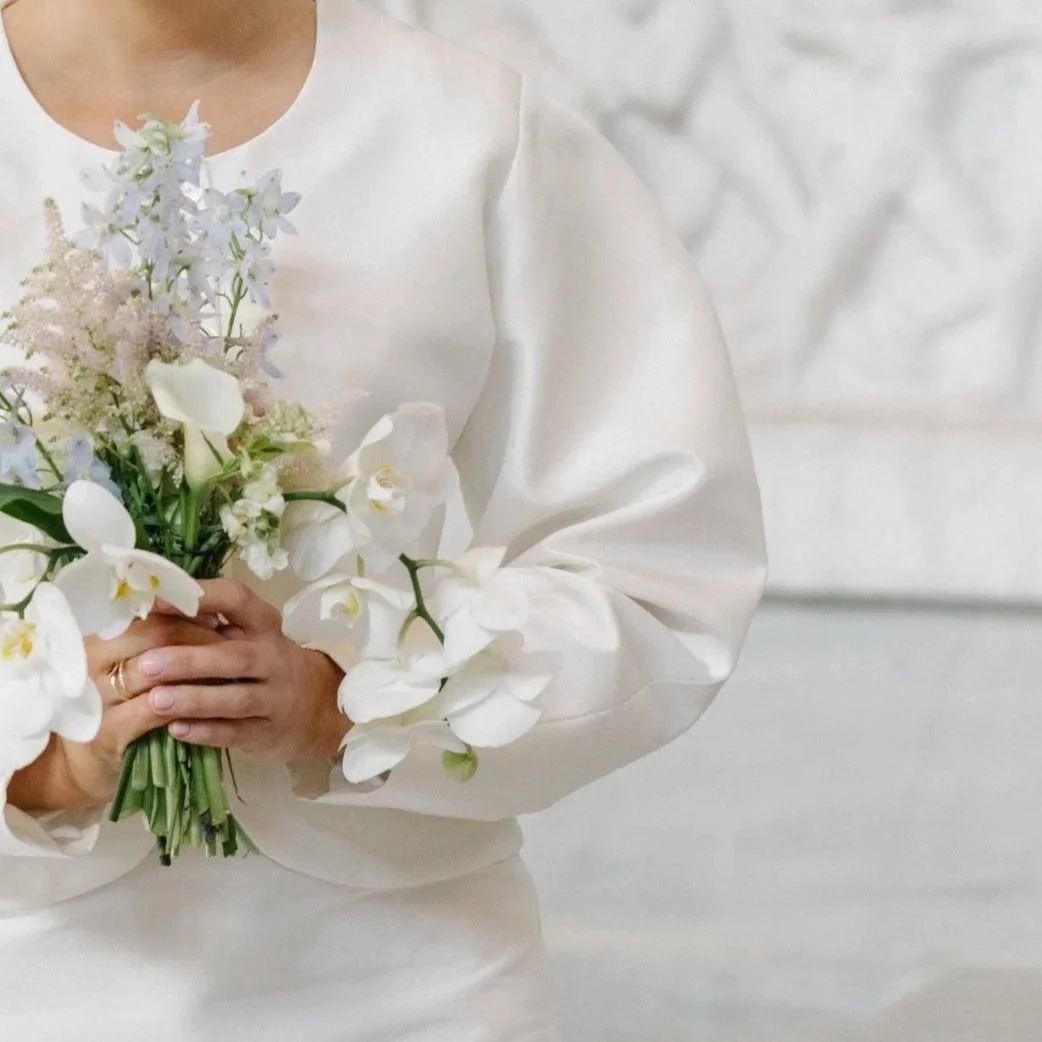 Minimalist bridal garment made from silk, highlighting fabric drape, precise tailoring, and understated elegance.