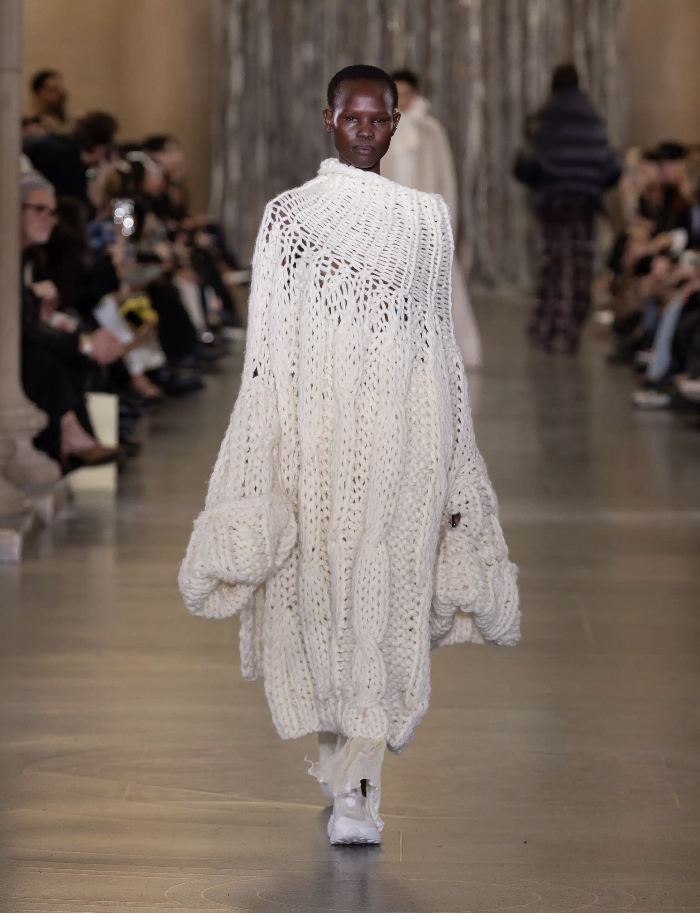 Handcrafted knitted garment developed as part of a runway showpiece, exploring texture, transparency, and artisanal techniques in contemporary fashion design.