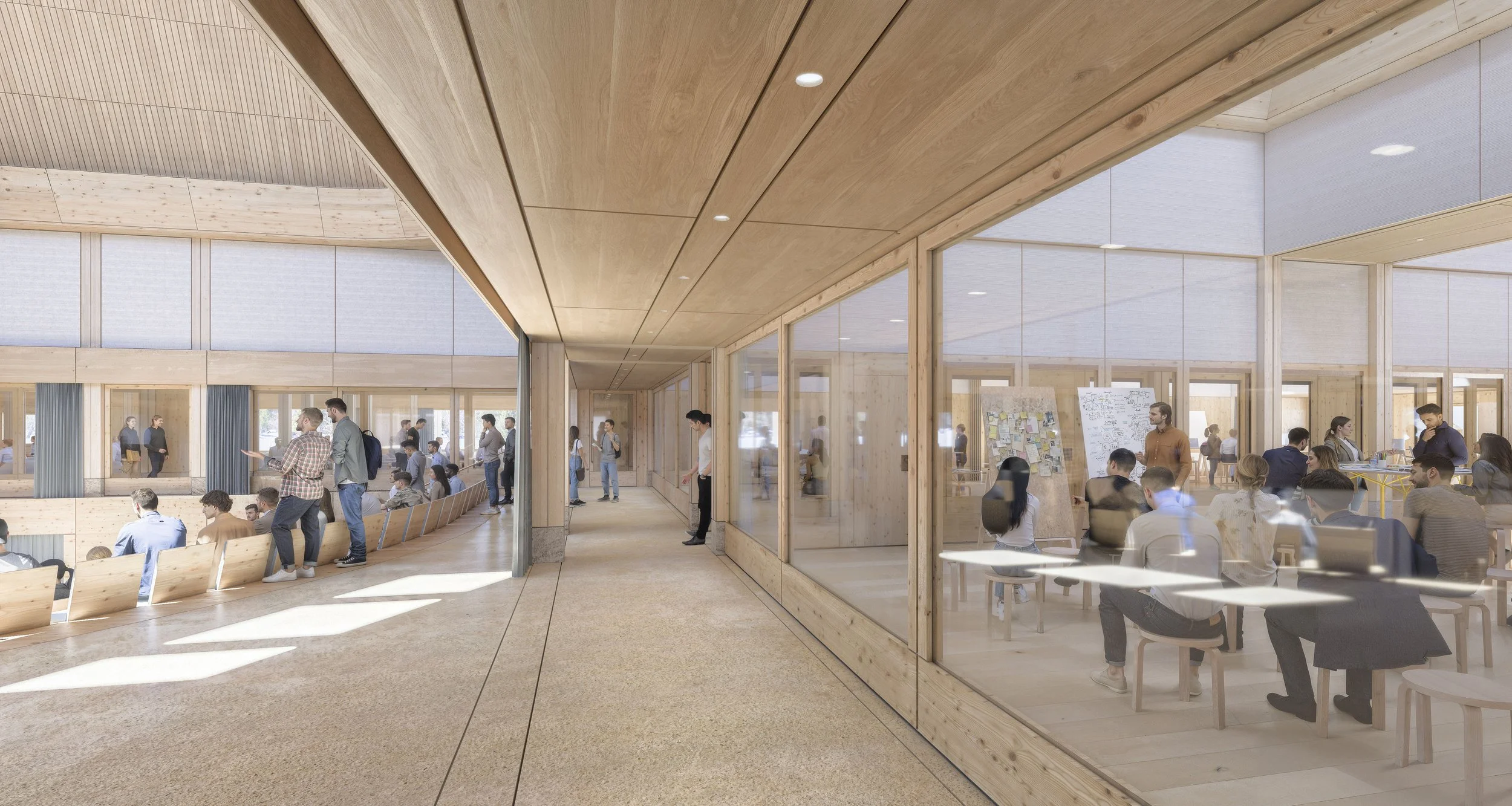 People sitting and standing in a modern, wooden-floored lobby area with large glass walls, a conference room with seated participants and a presenter, and an open corridor with more people walking and talking.