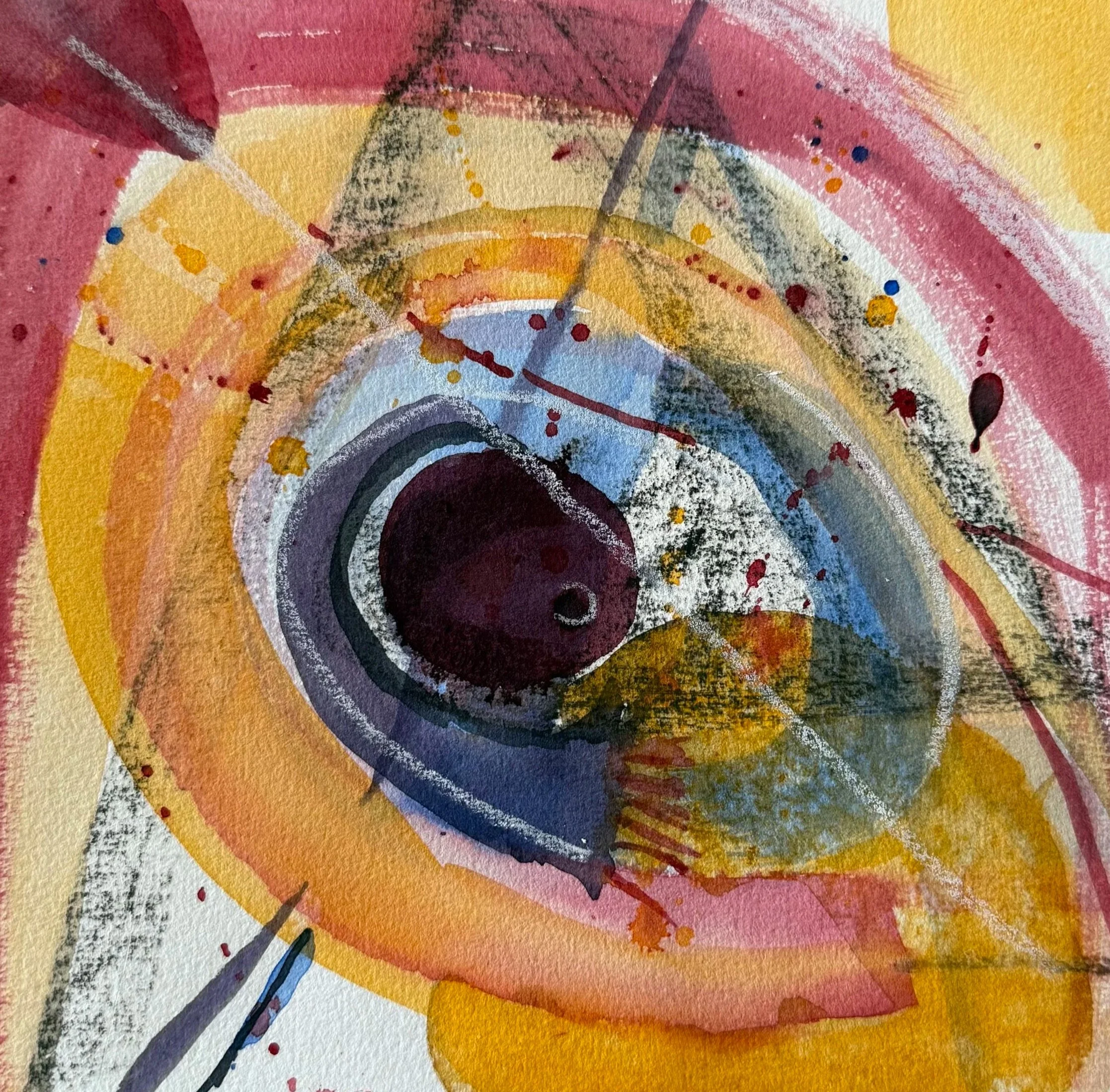 Close-up of an abstract watercolor painting featuring concentric circles in shades of pink, yellow, purple, and black with splatters of visible paint.