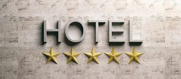 Sign with the word 'HOTEL' and five gold stars below it, indicating a five-star hotel rating.