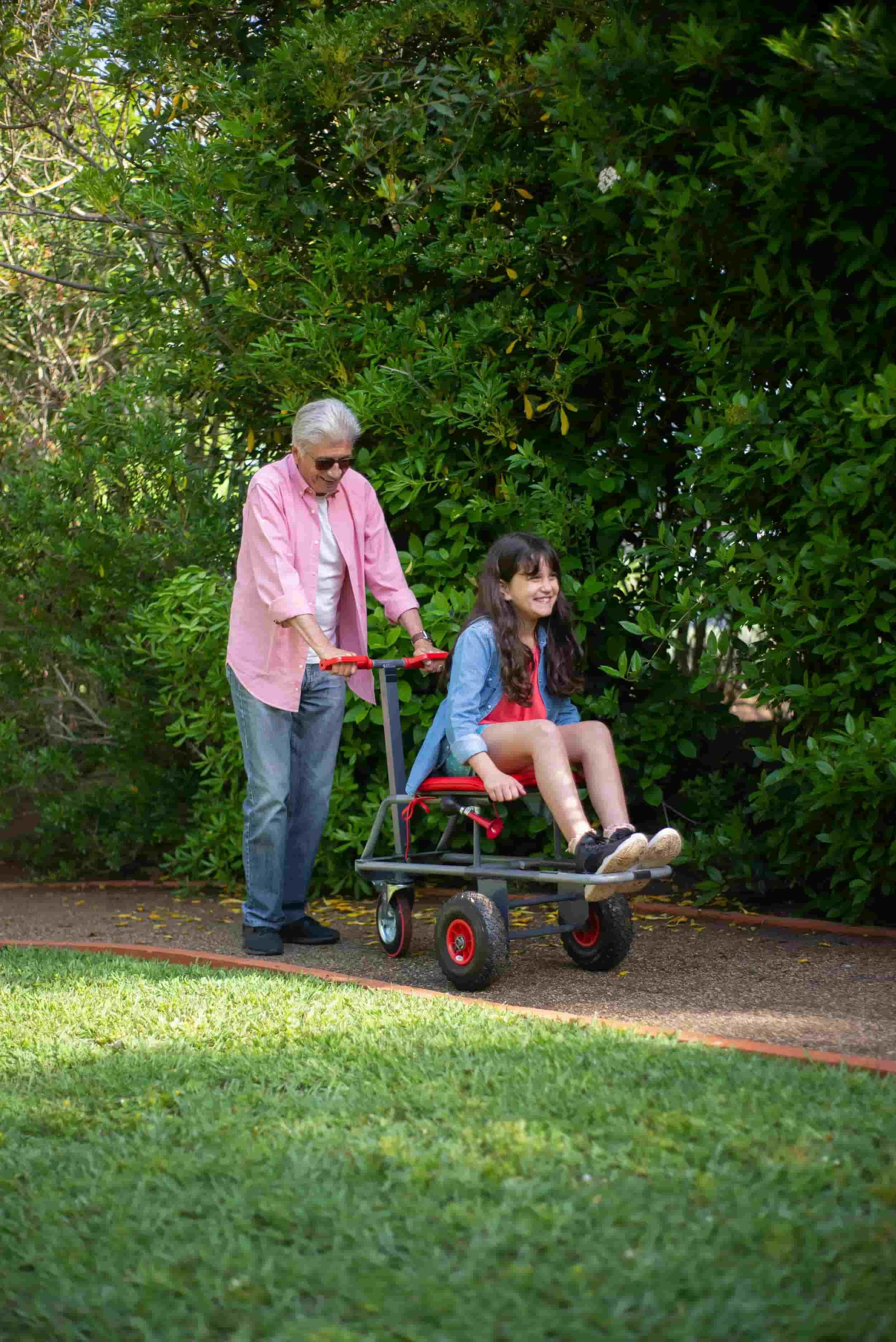 Grandfather, after his pain rehabilitation San Francisco, enjoying a walk with her granddaughter in a park.