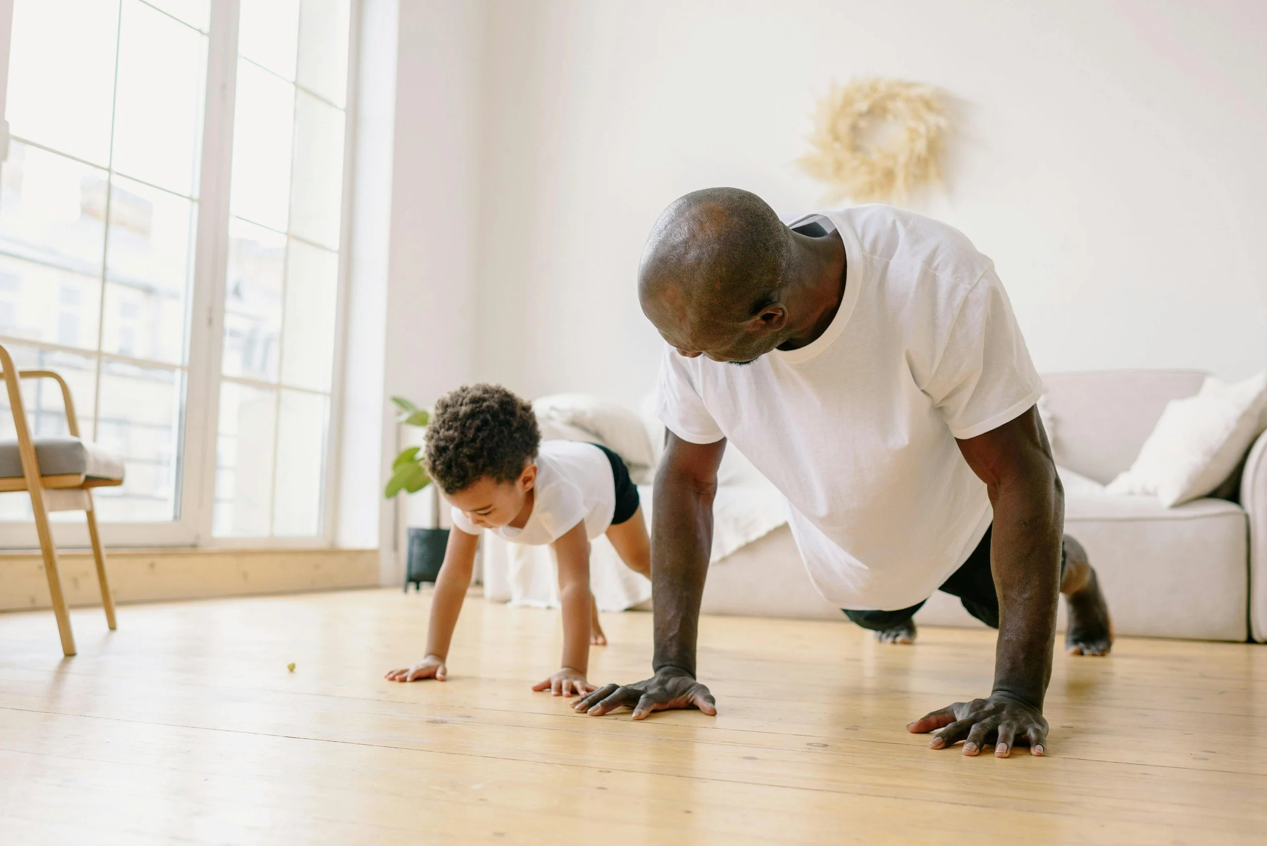 Father showing an exercises to his young son. He's just received targeted pain management San Francisco.