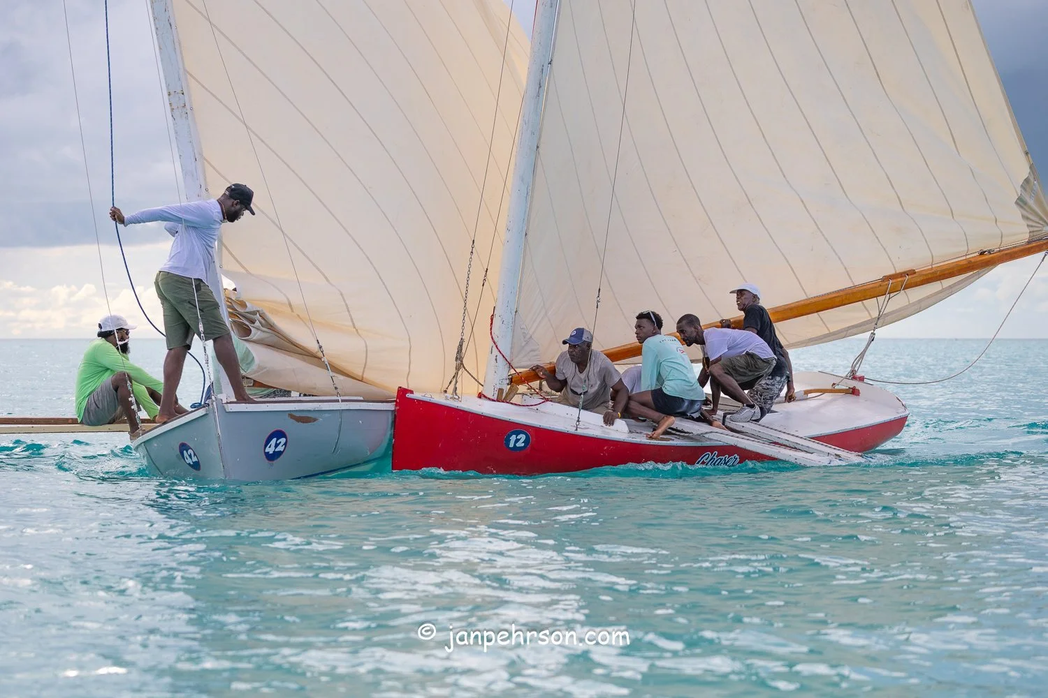 October 2025, Black Point, Exuma, Bahamas, Black Point Regatta, Final C-Class Race Finish. Swirling Winds in Squalls Brought Chaos!