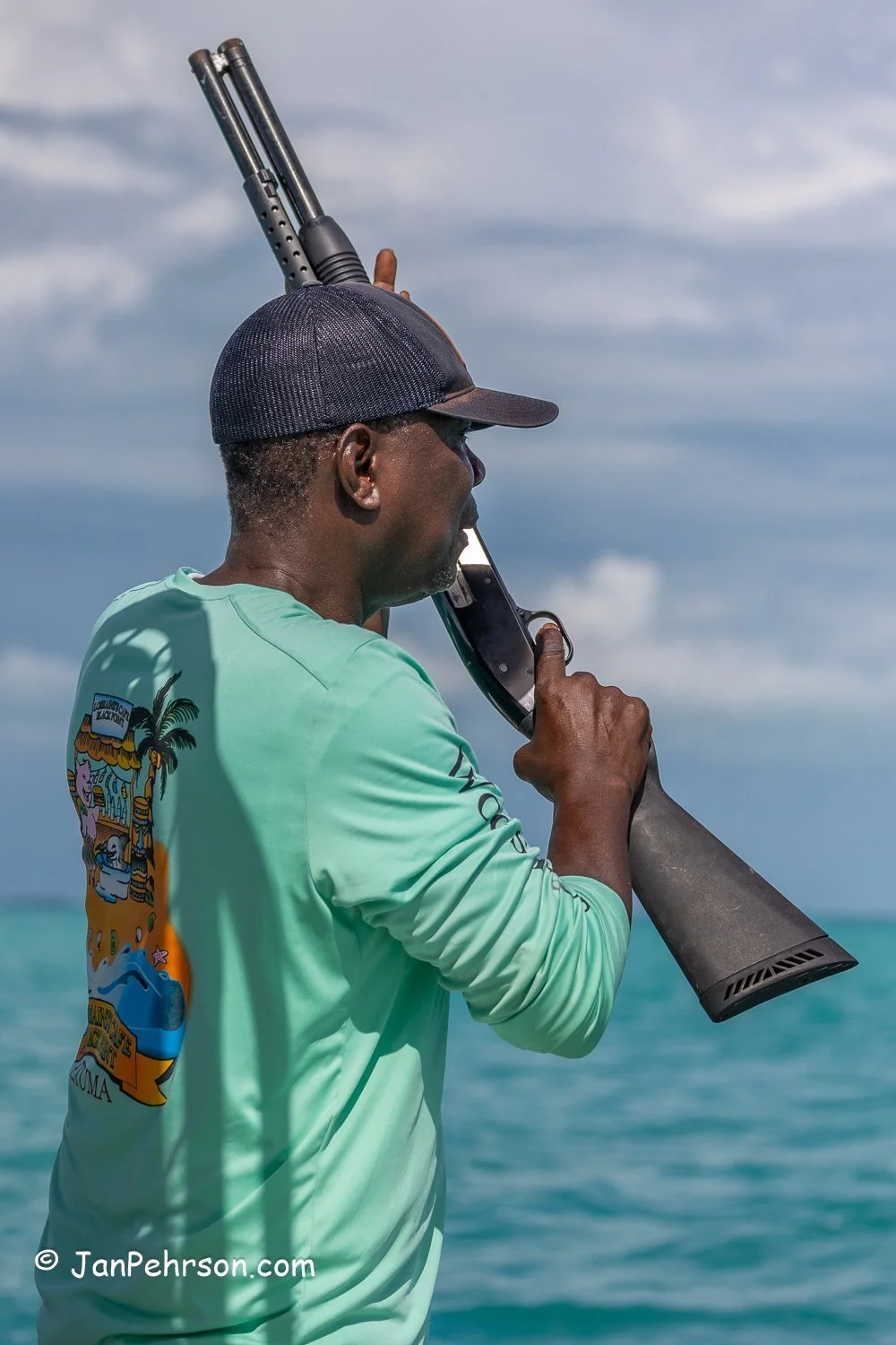October 2025, Black Point, Exuma, Bahamas, Black Point Regatta, E-Class, The Major of Black Point shoots a shotgun at the race finish