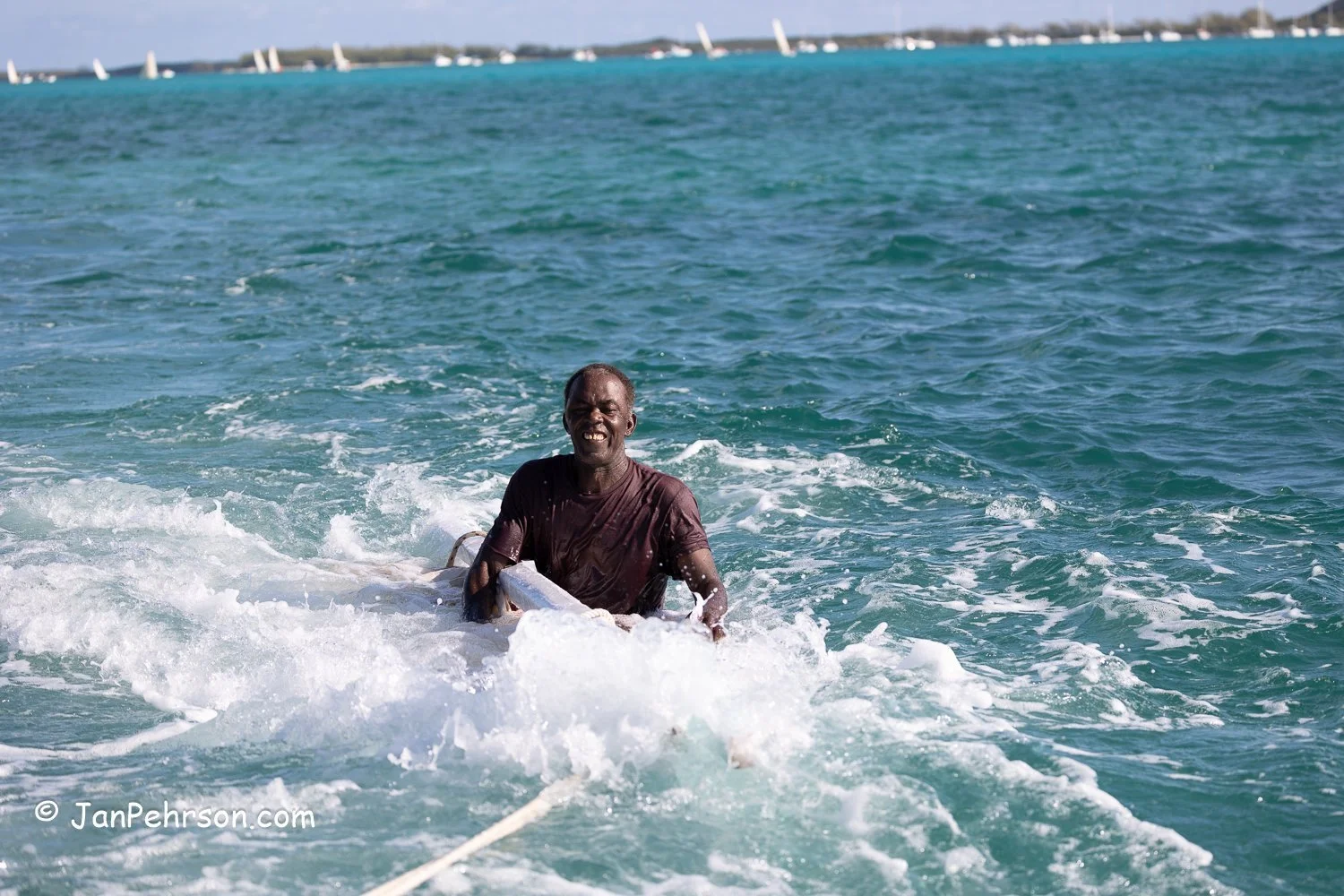 April 2023, George Town, Bahamas, National Family Island Regatta, Towing a sunken sloop back to the dock