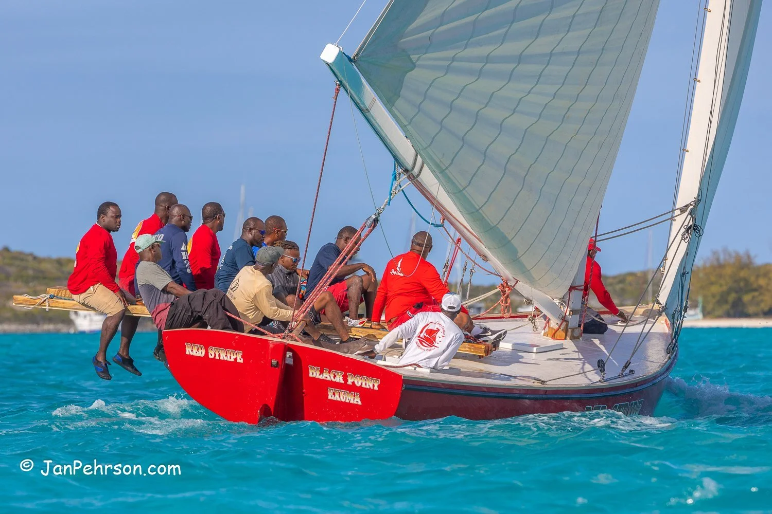 April 2023, George Town, Bahamas, National Family Island Regatta, A-Class, Red Stripe, from Black Point, Exuma