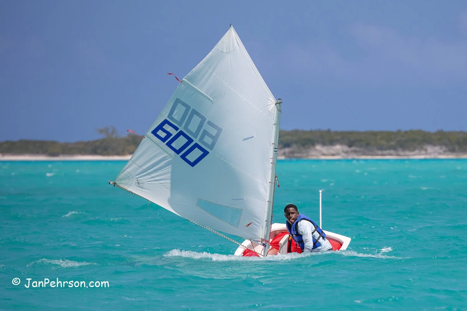 Clinton Romer of the Green Fleet fights to control his Opti in the 20 mph gusty winds and choppy seas