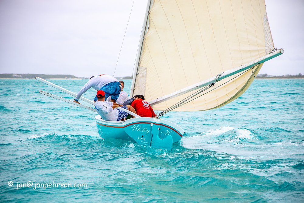February 2019, Farmers Cay Regatta. Class C Sloop "Whitty K", Regatta Winner. The crew jump on the pry board during a tack. 