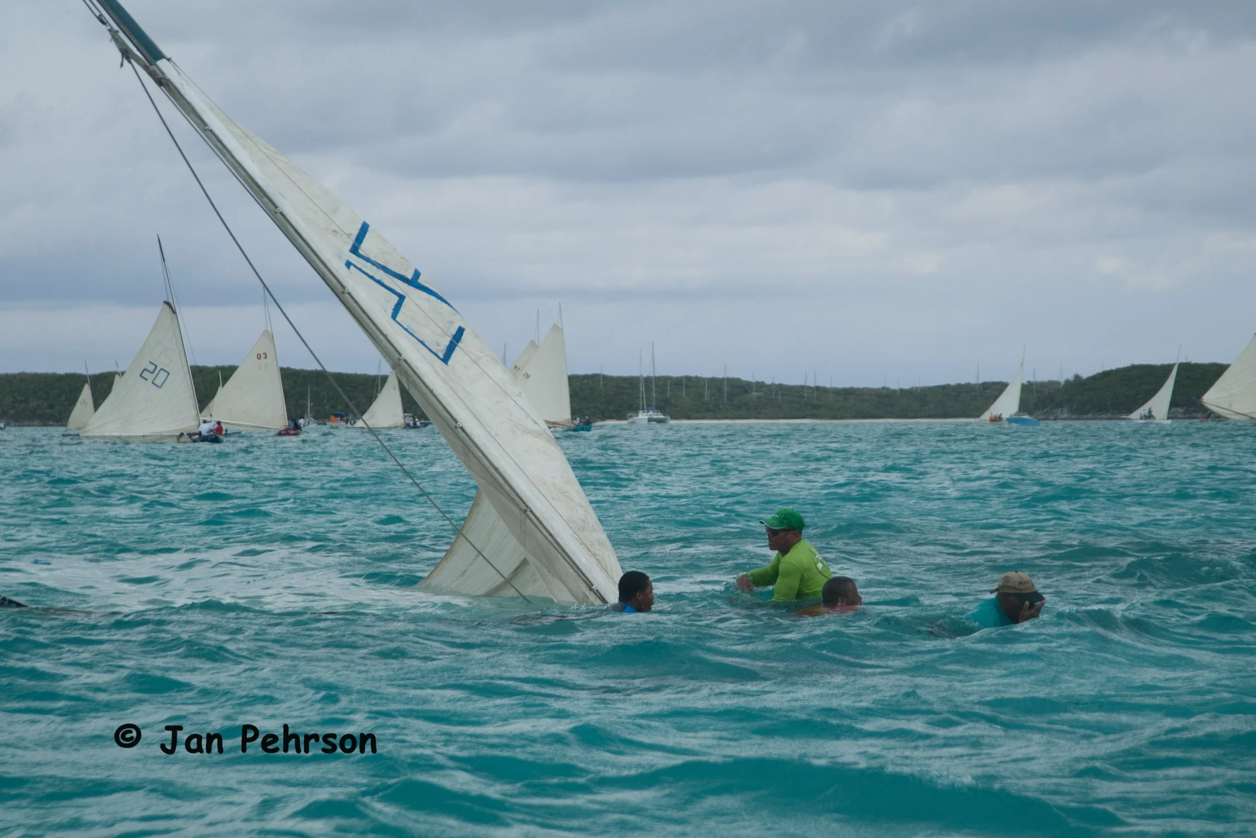 April 2018, Georgetown, Exuma, Bahamas, National Family Island Regatta, Day 3, Class C, 5 boats sank today in gusty conditions, need to get the lead ballast out and refloat (0250)