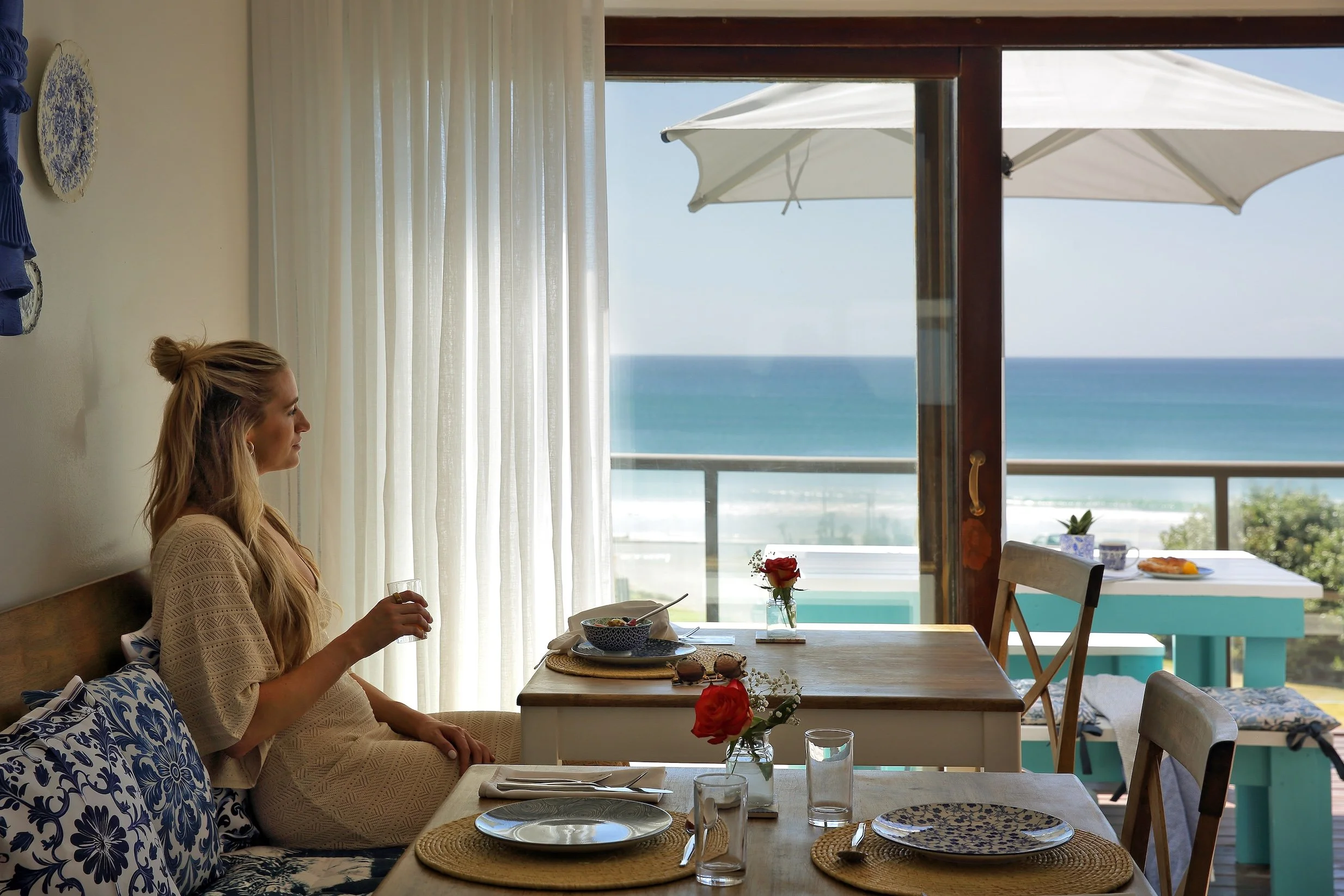 Guest enjoying breakfast with ocean views from a private balcony at Mykonos Luxury Guest House in St Francis Bay.