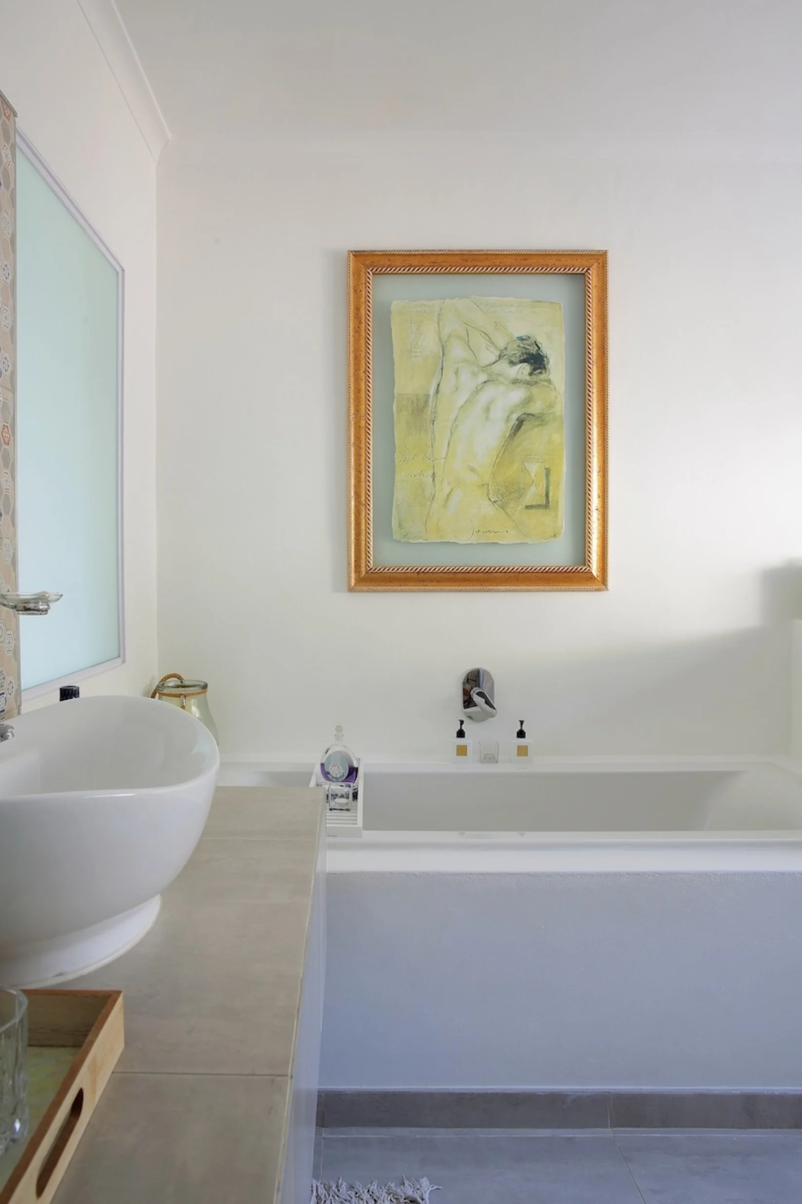 En-suite bathroom with bathtub and basin in deluxe sea-facing room at Mykonos Luxury Guest House.