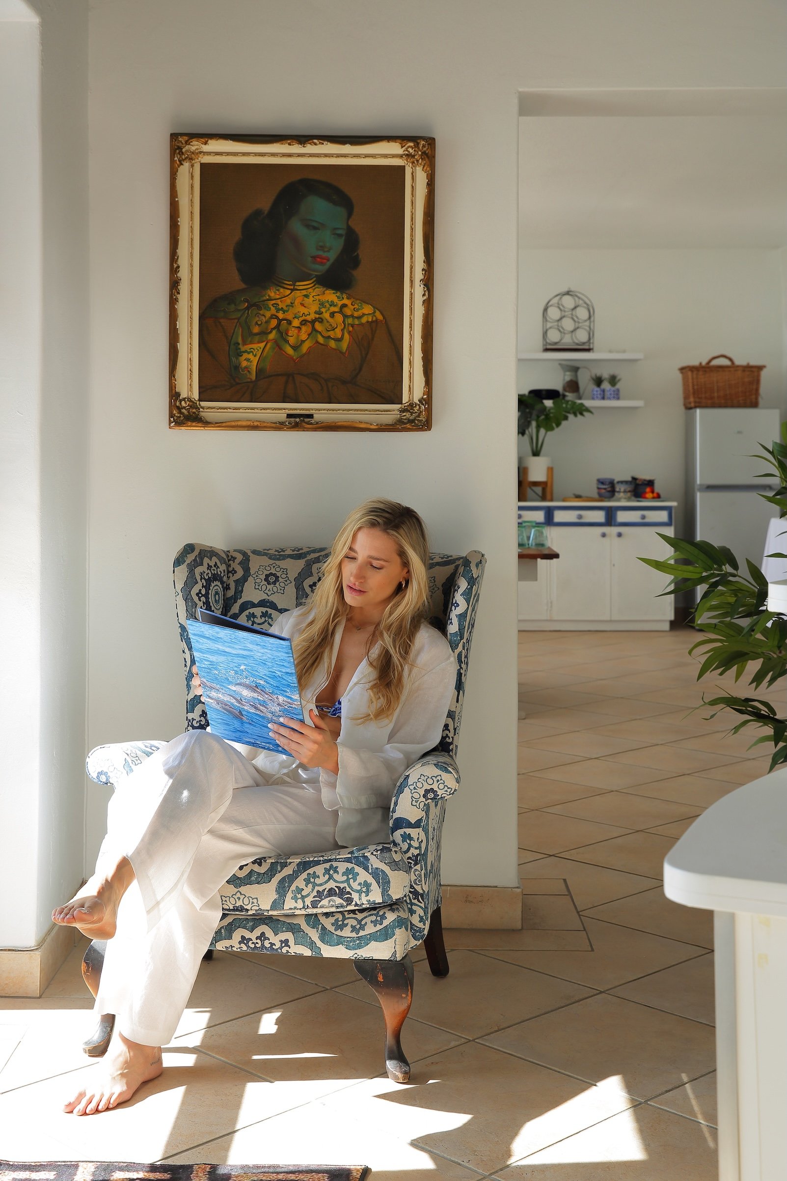 Guest relaxing in elegant lounge at Mykonos Guest House in St Francis Bay, featuring coastal-inspired interior and natural light.