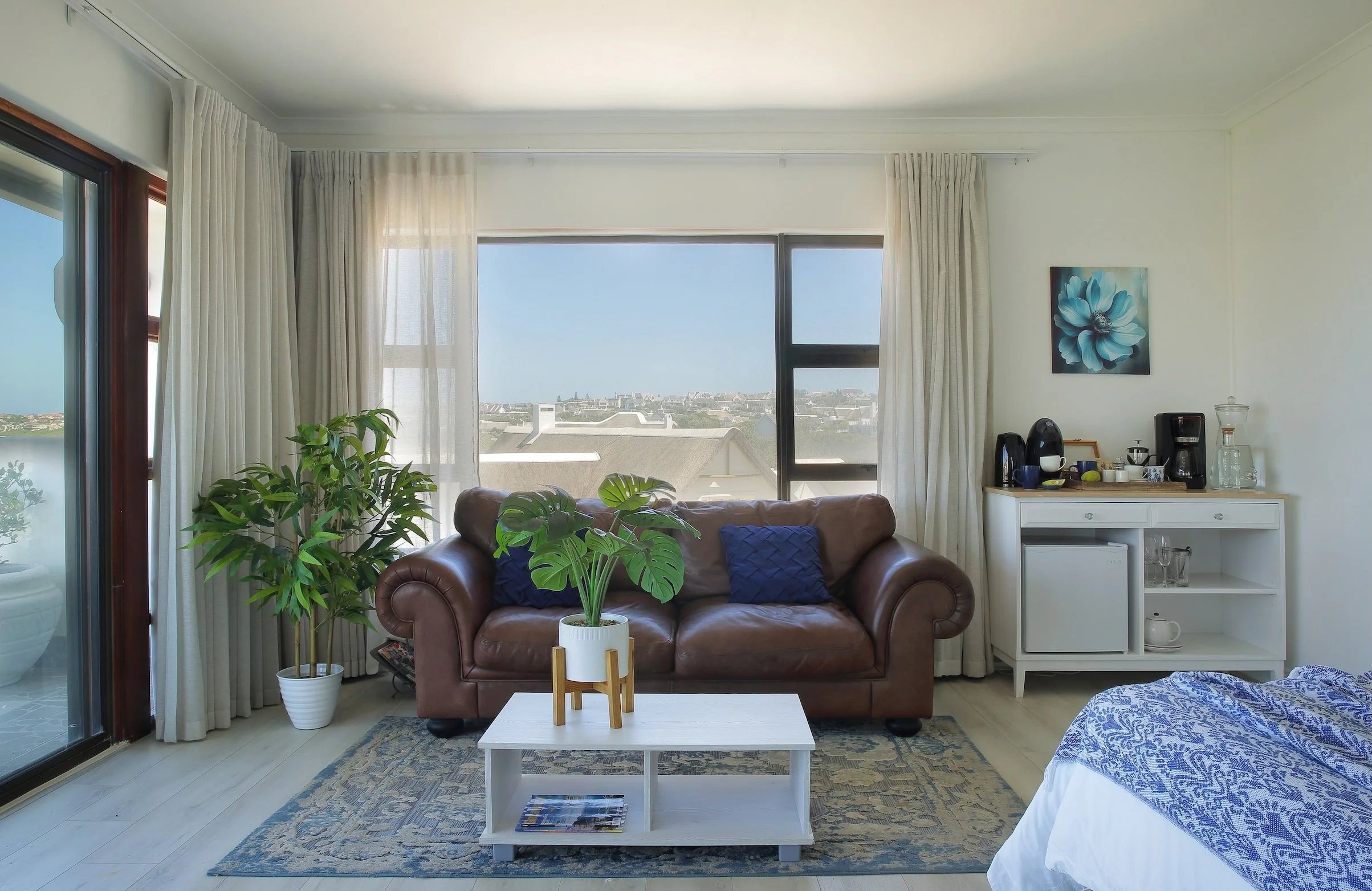 Bright suite with leather sofa, coffee station and sea views in St Francis Bay accommodation.