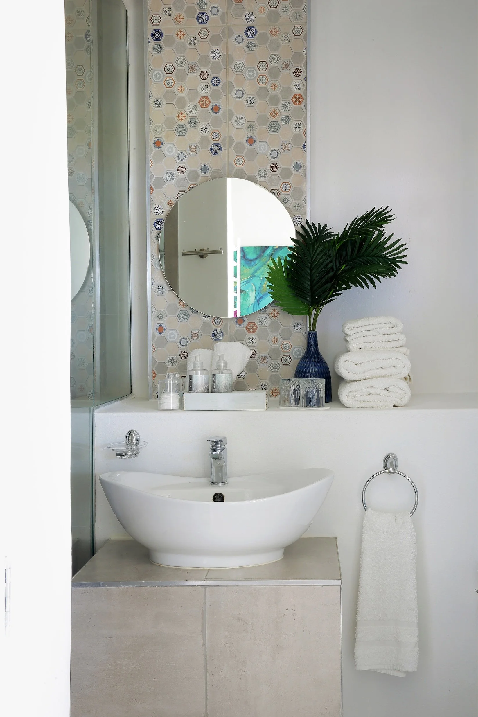 Modern en-suite bathroom with hexagon tile feature wall, walk-in shower and vessel basin at Mykonos Guest House.