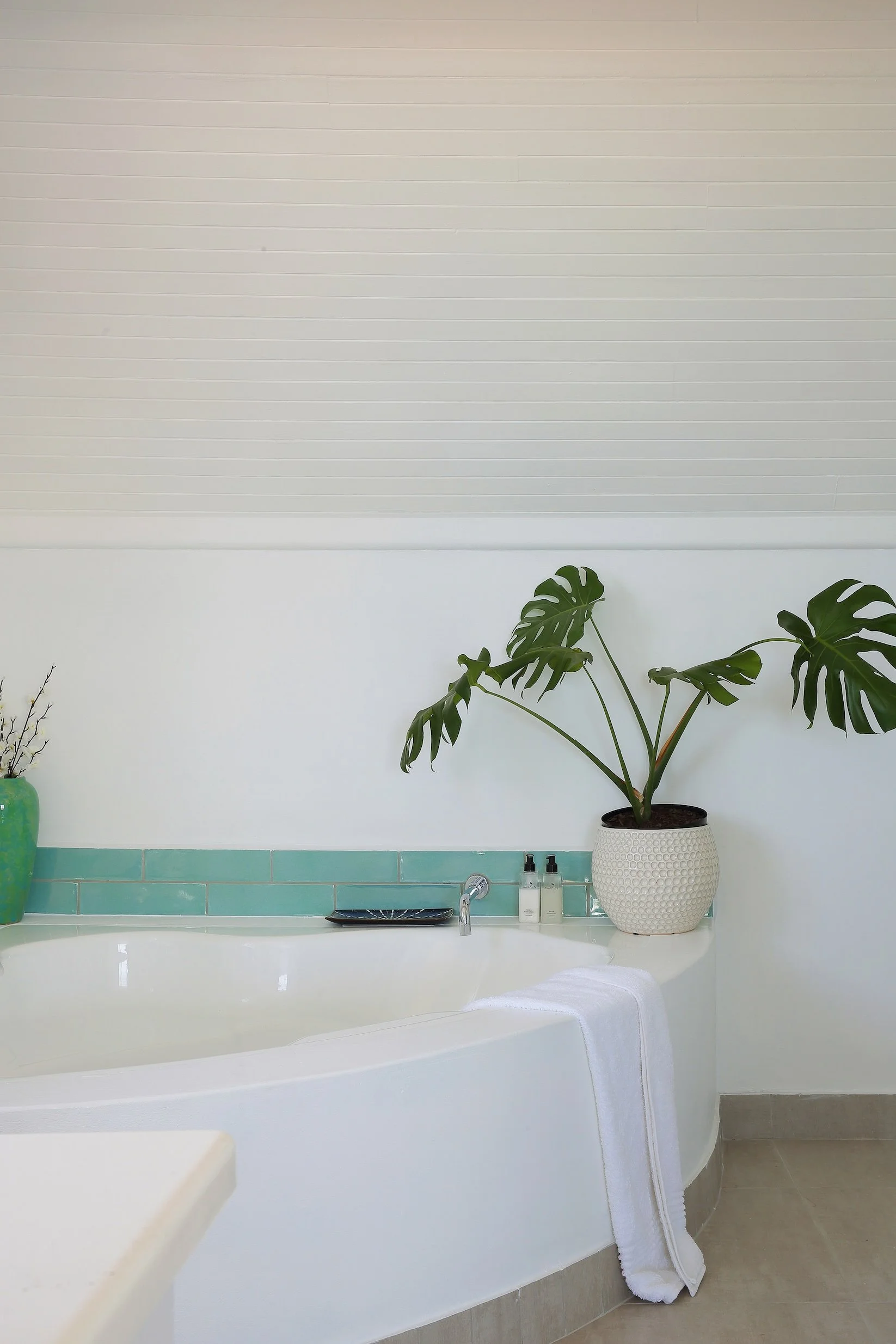 Modern en-suite bathroom with freestanding bath and coastal-inspired decor at Mykonos Guest House.